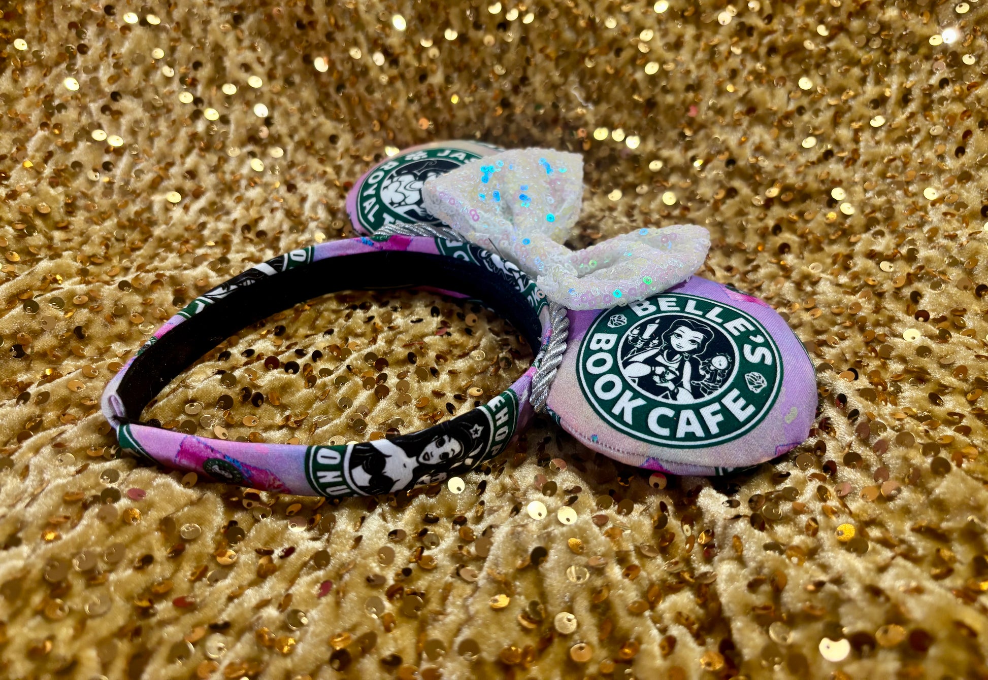 Handmade and ready to ship custom ears with popular coffee themed with princesses on fabric. White iridescent bow and silver twisted trim on a universal sized headband with matching design as the mouse ears.