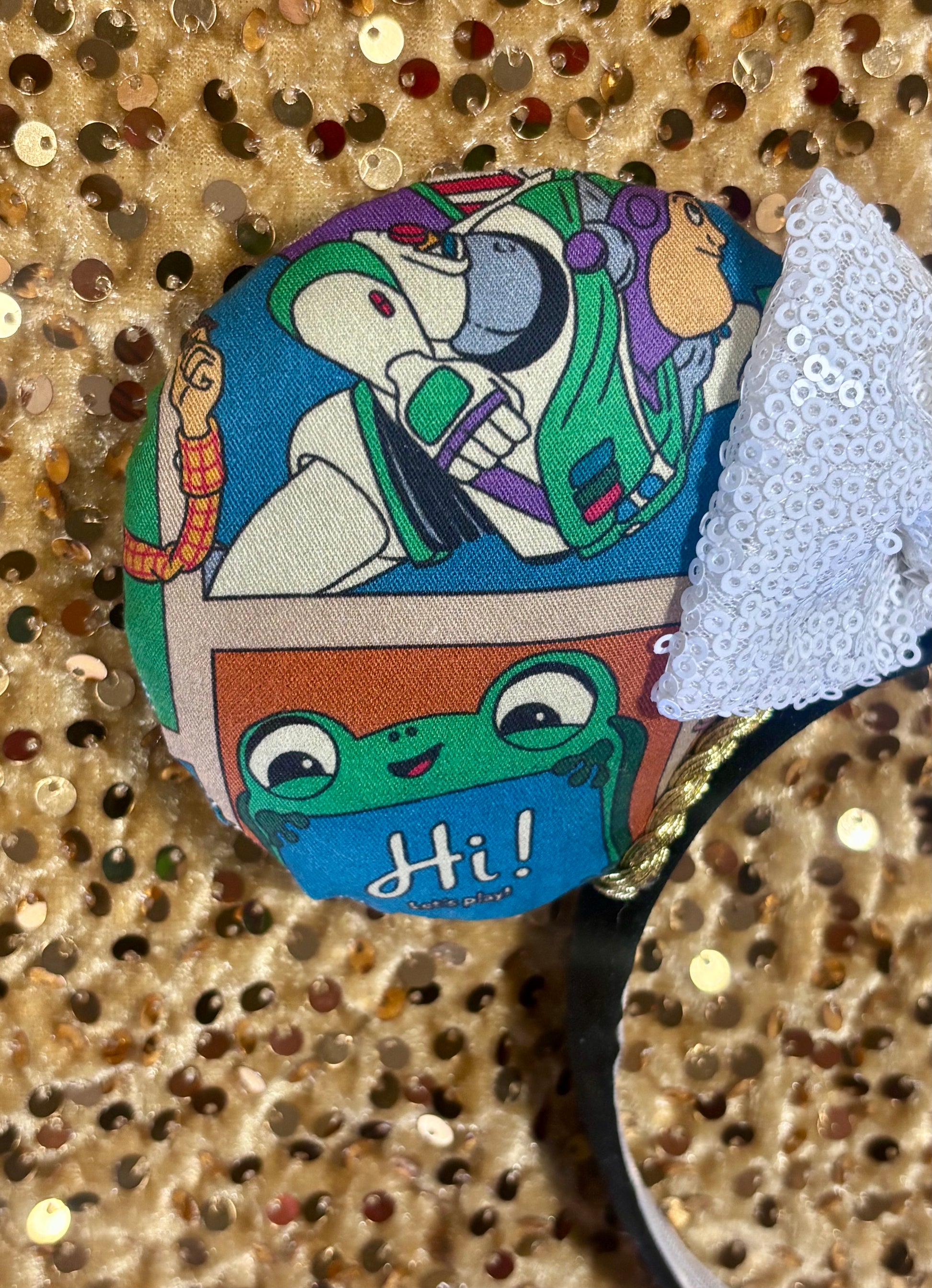 Handmade and ready to ship TS5 Inspired mouse ears. The character fabric is on the front and the back. On a universal sized black poly fabric headband. With a white sequin bow.