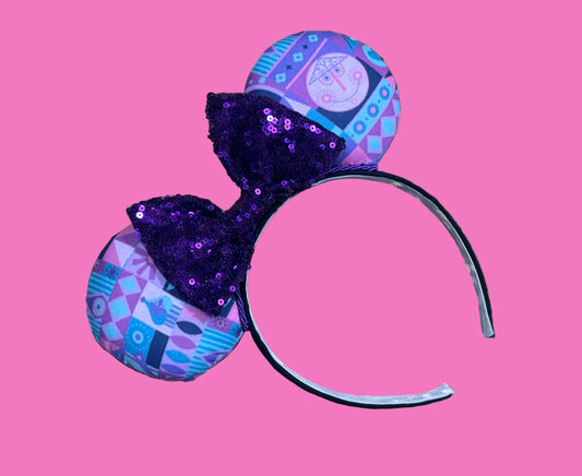 Handmade and ready to ship. Small world inspired Mouse ears. The fabric is on the fabric front and back with purple twisted trim and a purple sequin bow on a universal sized black headband.