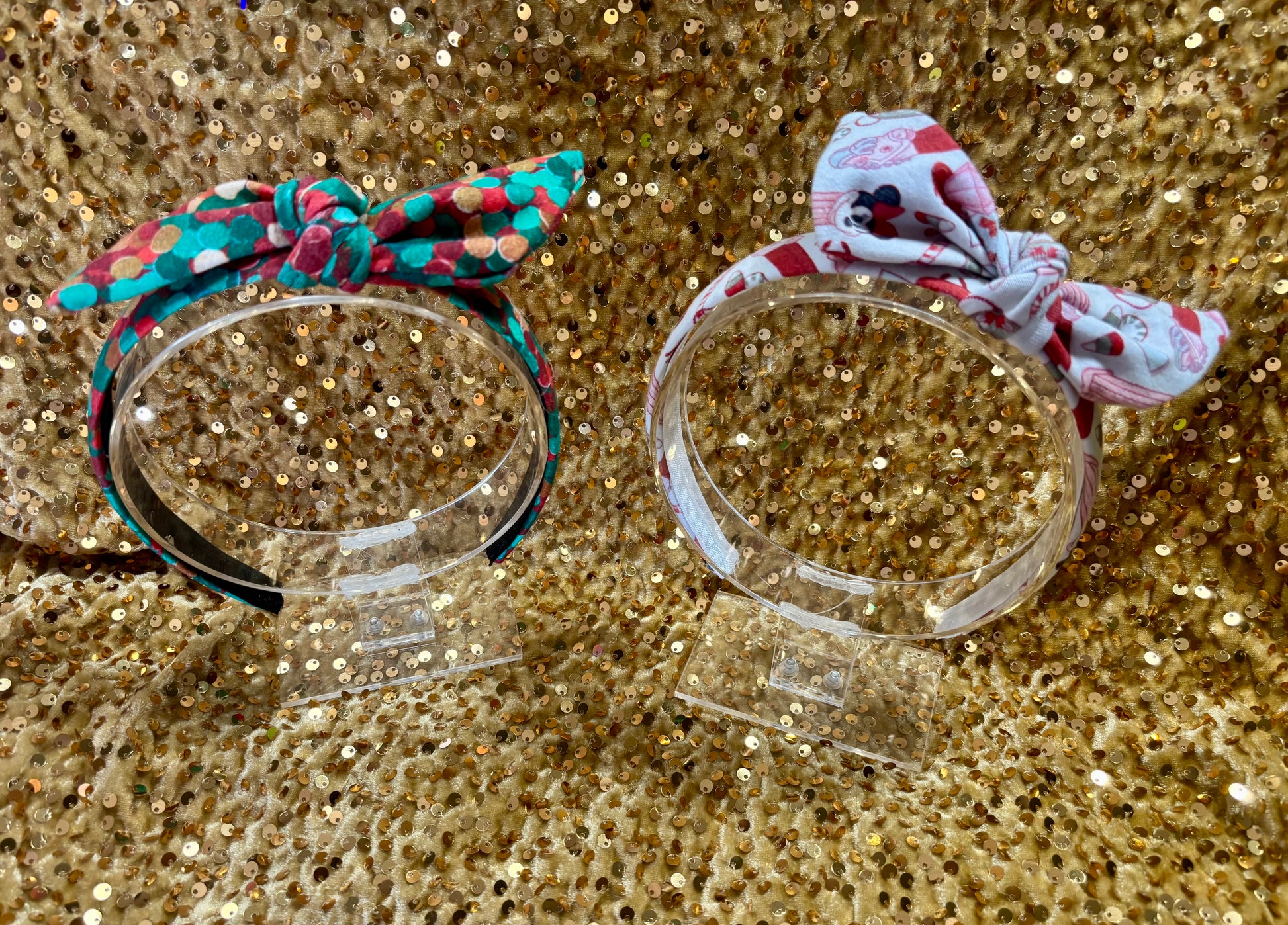 Two Handmade and ready to ship twisted bow headbands with designs in Christmas dots and Stocking Stuffers. Fabric is a soft and stretchy cotton Lycra fabric on universal sized headbands. 