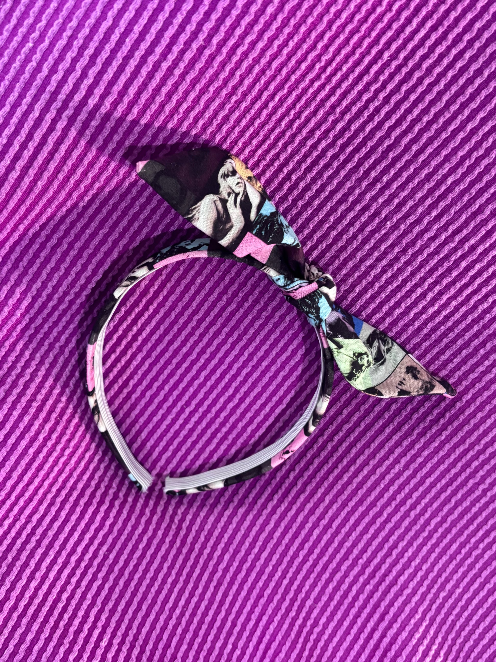 Decorative headband with swiftie design on a purple textured background