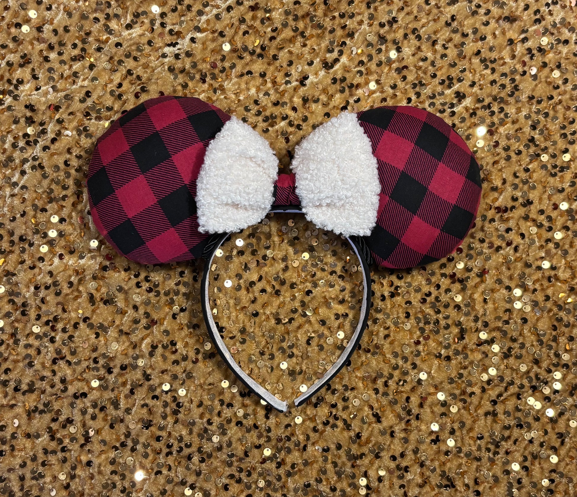 Buffalo Plaid mouse ears on a glittery gold background