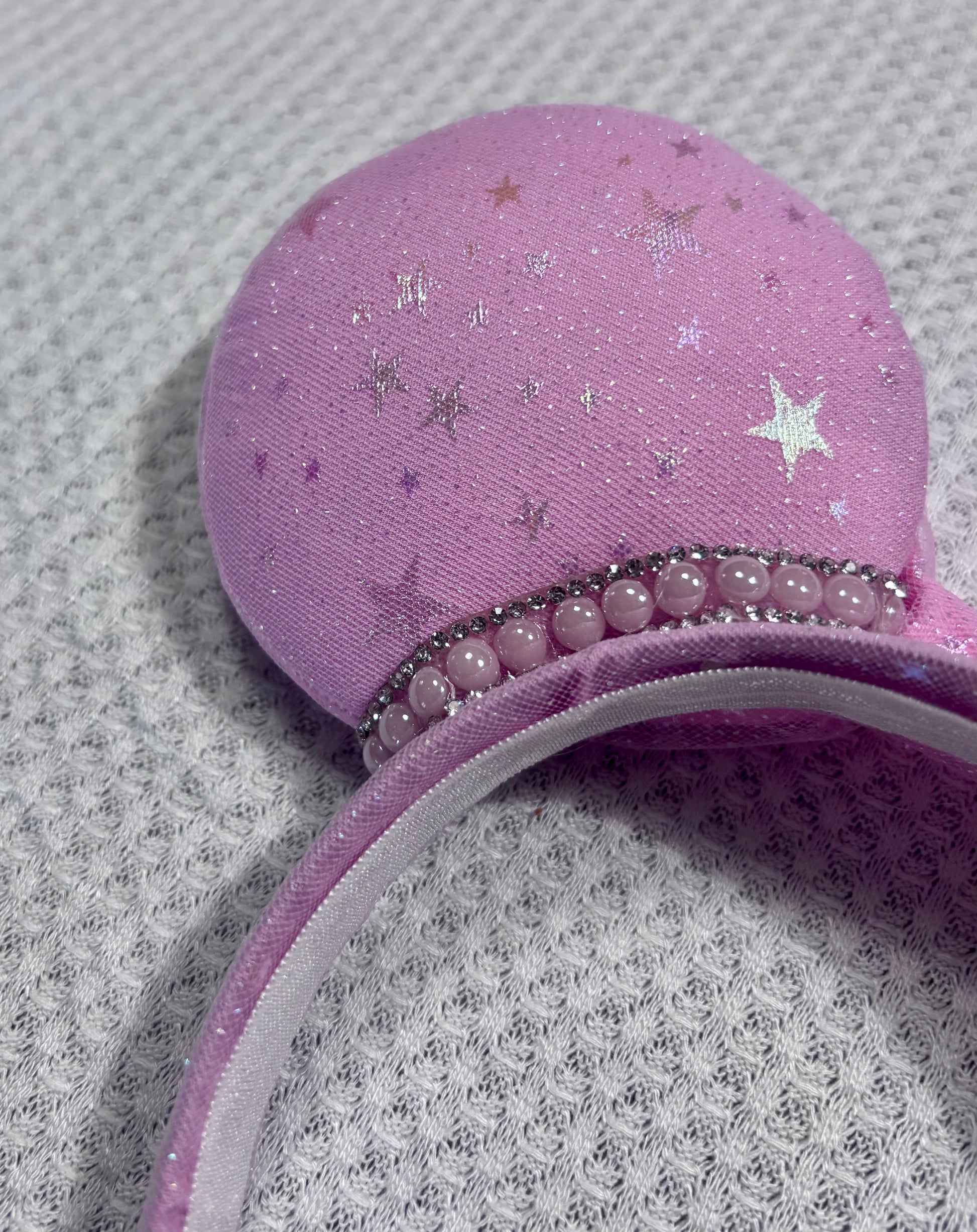 Handmade and ready to ship Pink Sparkling Iridescent fabric on pink to make mouse ears with the fabric on both the front and back along with the headband the is universal sized and fits most. The set has a matching bow, but you can request any sequin color in your order and I'll attach it. Item is shown on a white background.