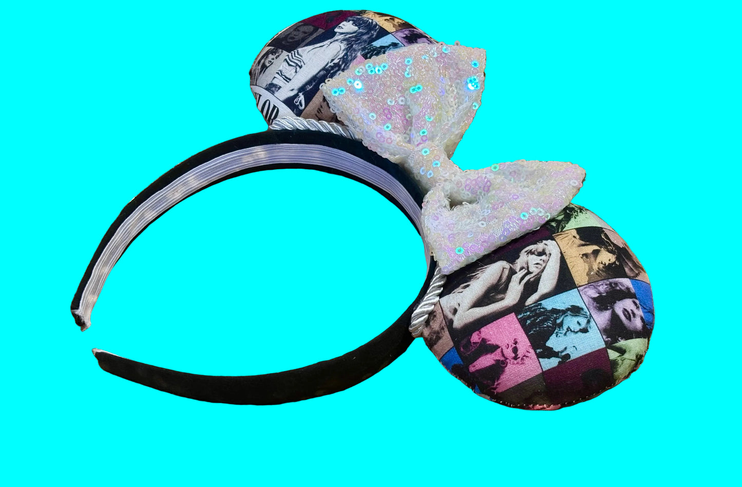 Eras Mashup Mouse Ear headband with white iridescent sequin bow. You can request any color sequin bow in your order by leaving a note. Handmade and ready to ship with fabric on both the front and the back of mouse ears. The set has a silver twisted trim along the inner ears. Ears are on a black poly cotton universal sized headband. Side view of headband.