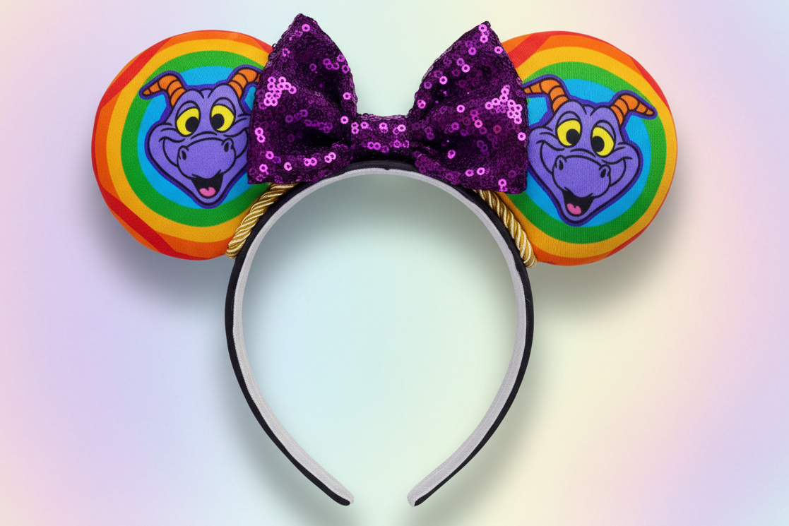 Colorful rainbow with Figment is on the mouse ears on a black headband with black twisted trim and sequin purple bow. Shown on a white background 