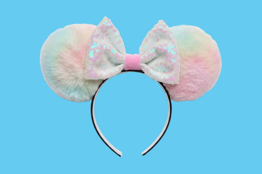 Handmade and ready to ship Fluffy Pastel-colored mouse ears with a white iridescent sequin bow on a blue background.
