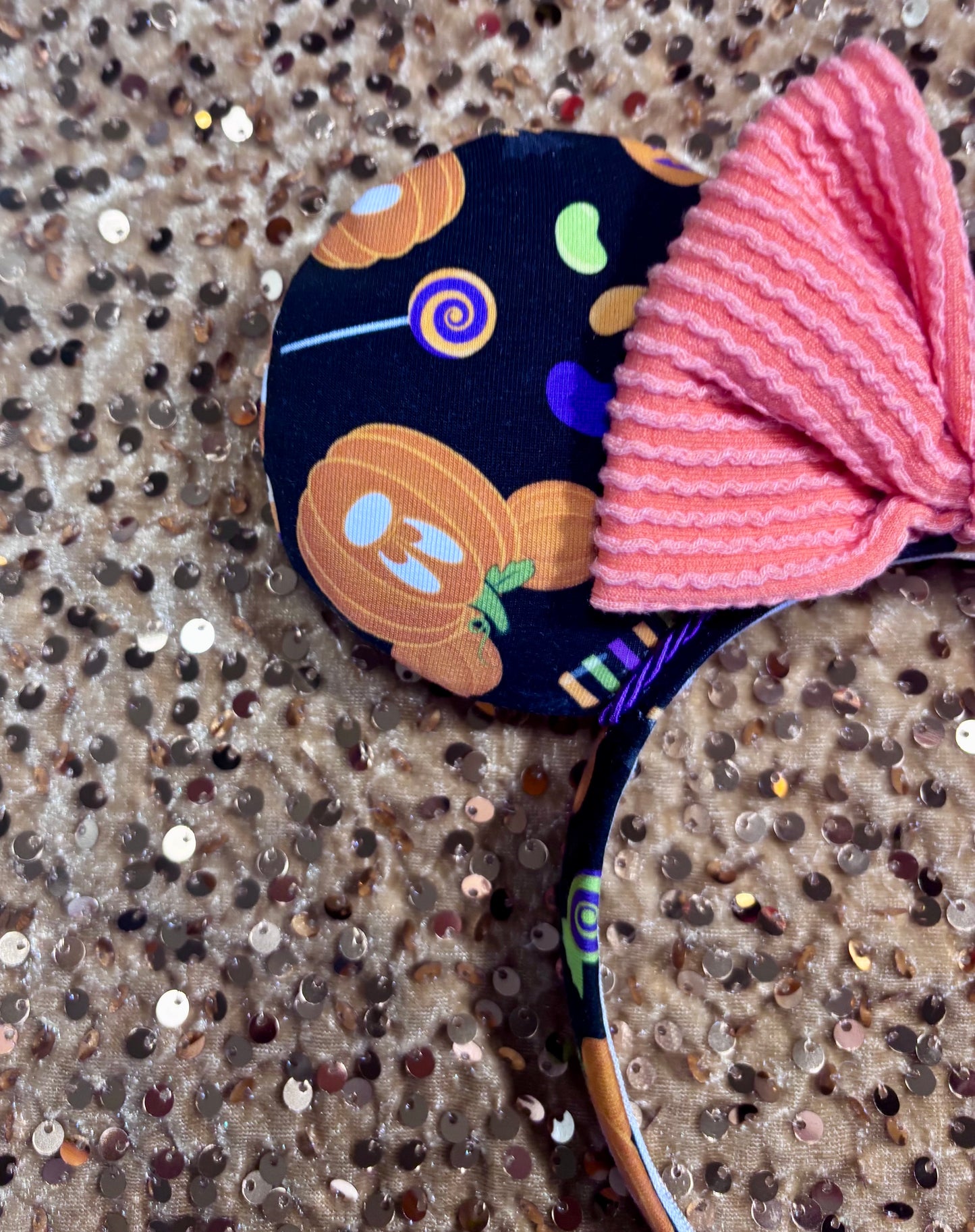 handmade mouse ears with halloween boo to you fabric on ears and the headband.  Orange waffle print bow