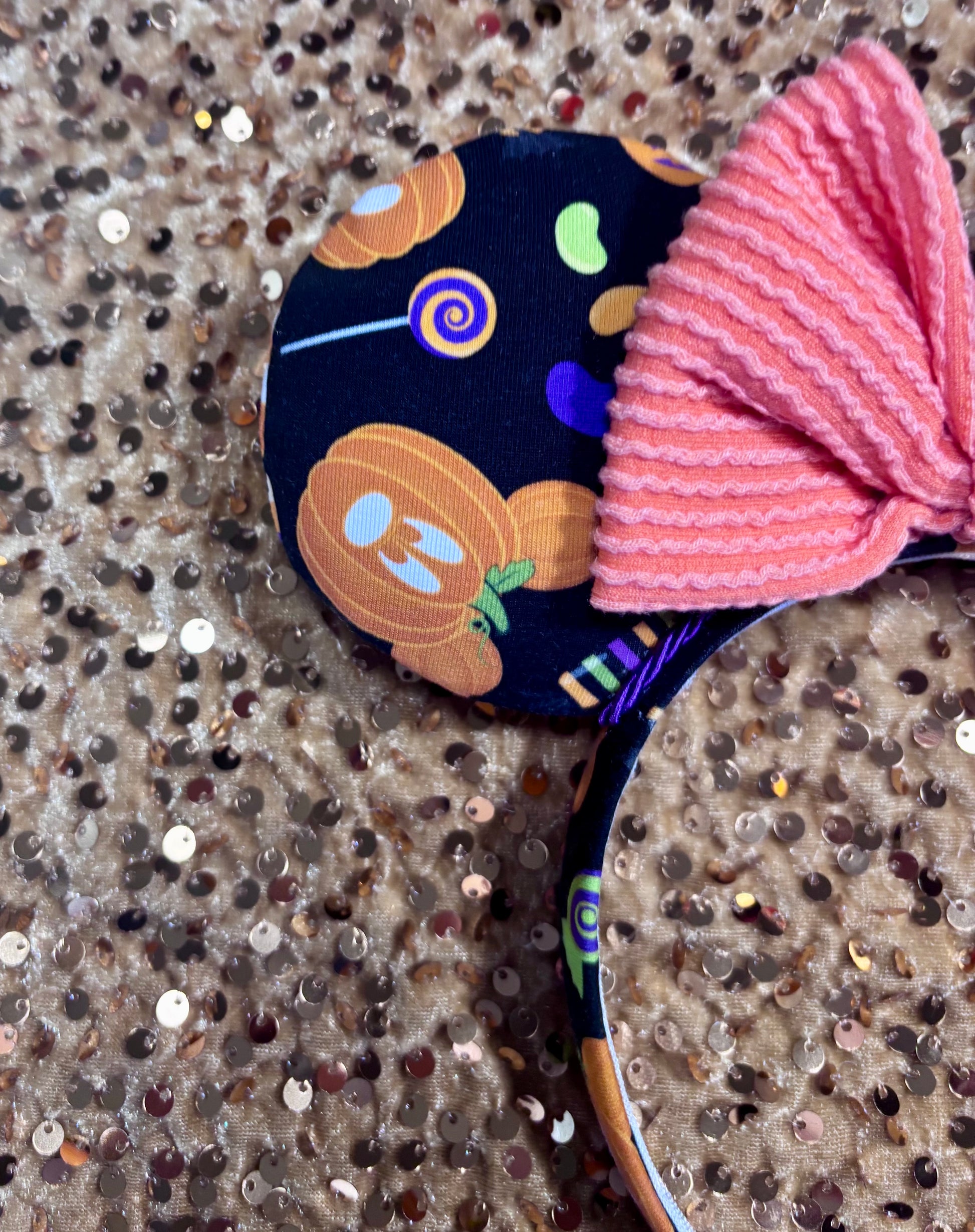 handmade mouse ears with halloween boo to you fabric on ears and the headband.  Orange waffle print bow