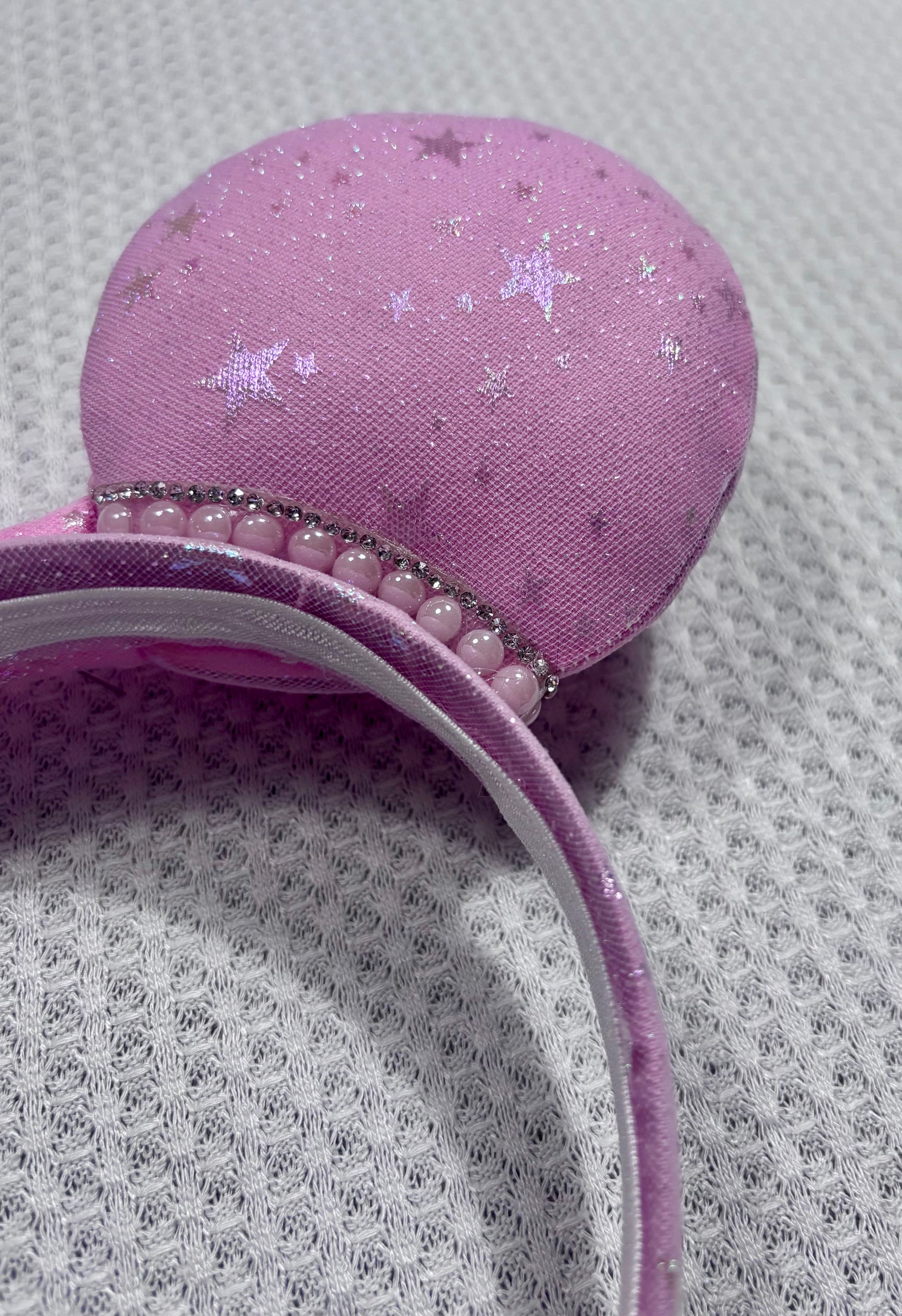 close up of pink mouse ears and rhinestone trim. 
