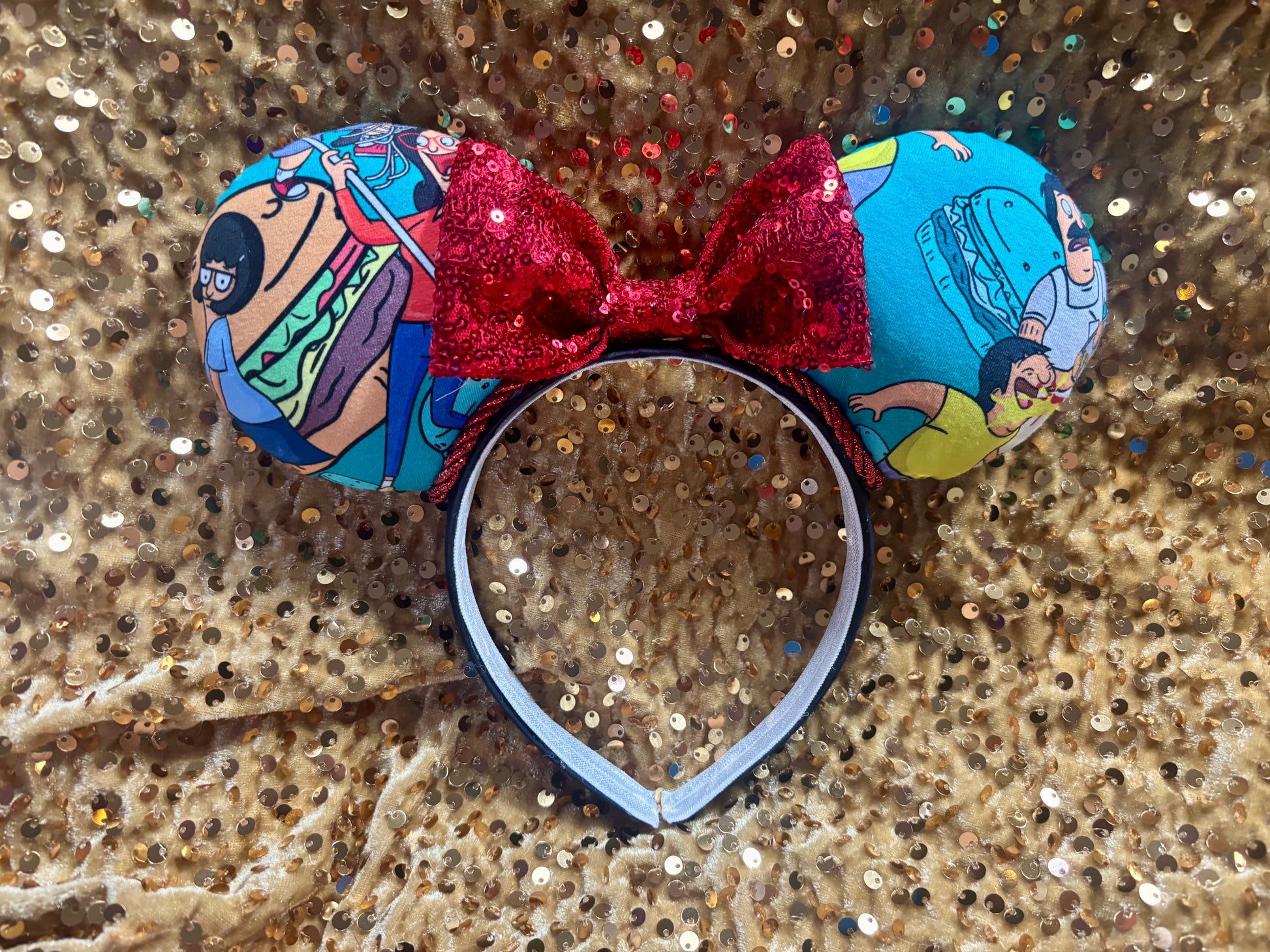 Handmade and ready to ship Burger Boss Mouse ears with the fabric on the ears, front and back and the bow is red sequins. The headband is a universal sized headband and has black poly cotton fabric on it.