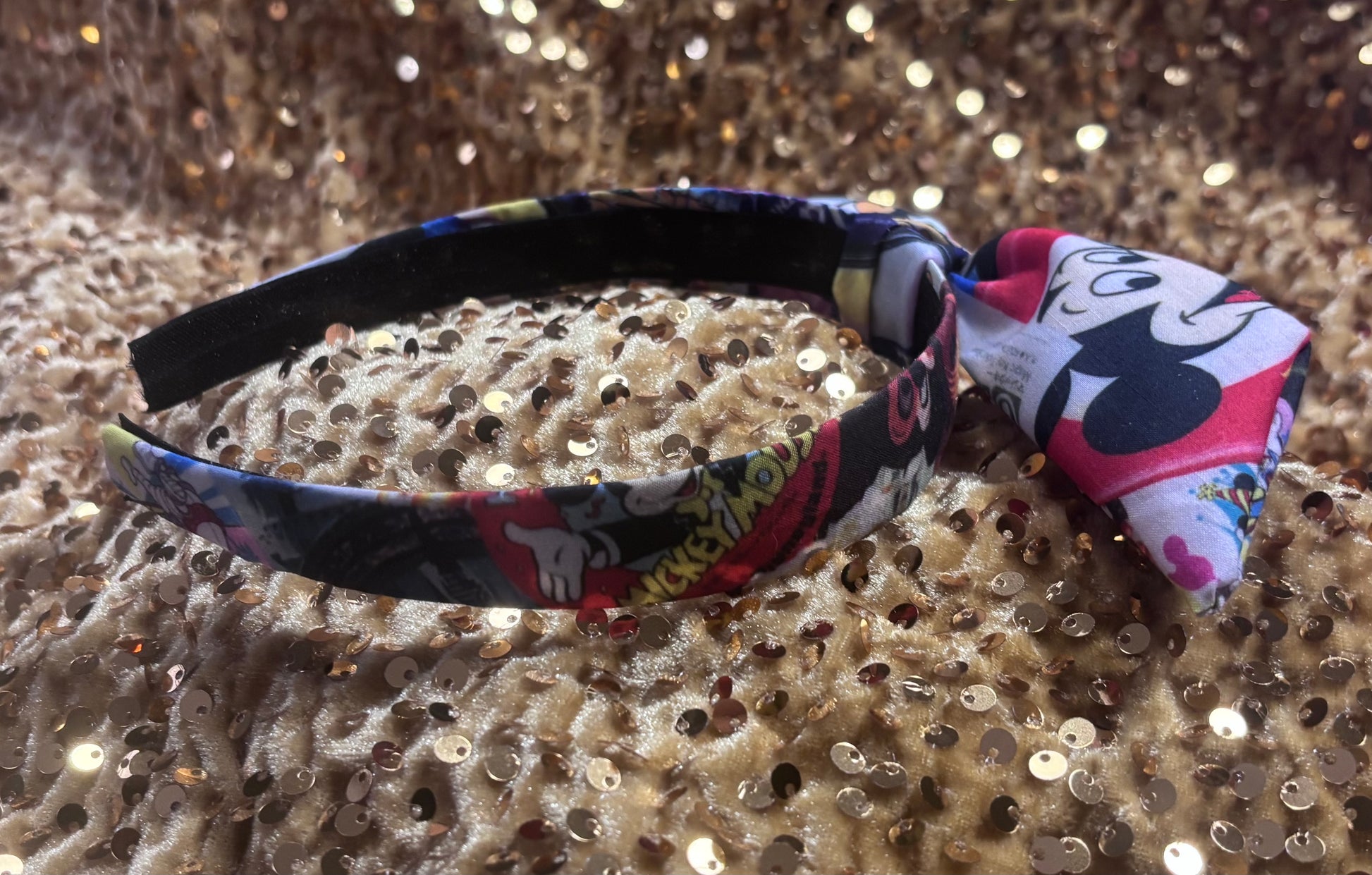 Other side of the headband with Park themed twisted headband showing views of Mickey and friends.