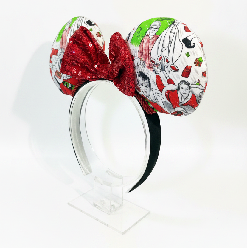 Decorative headband with red sequin bow and festive patterned ears on a white background