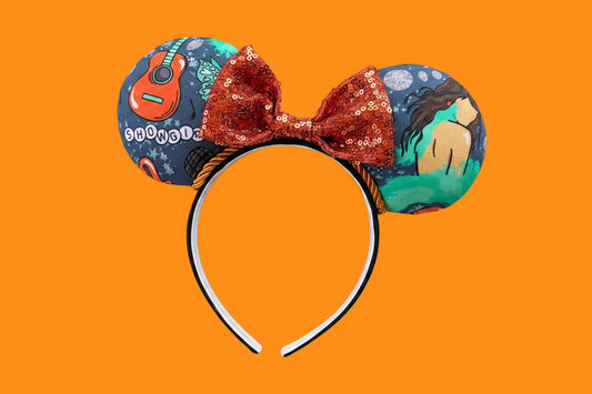 Handmade and ready to ship Actually Romantic Mouse ears with an orange sequin bow, orange twisted trim and on a black universal sized headband.