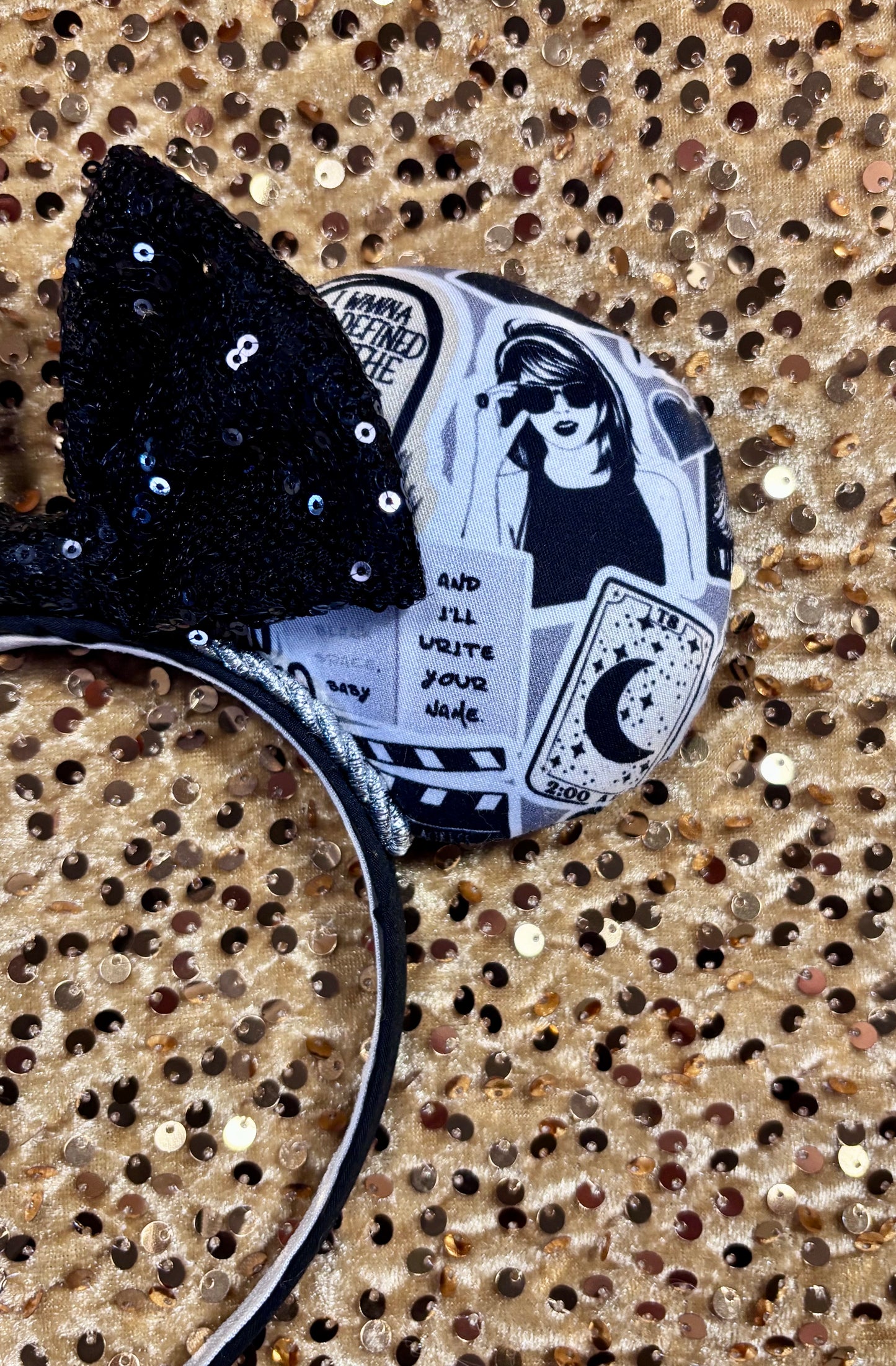 Handmade and ready to ship Mouse Ears with Black and White Swiftie sayings and pictures. has a black sequin bow.