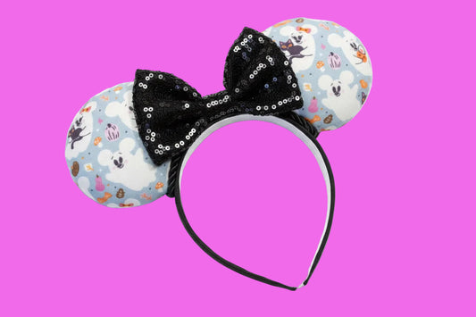 Handmade and ready to ship Halloween Cute Ghosts Mouse ears with the fabric with mouse shaped ghosts on fabric is on the ears, front and back and a black sequin bow. The headband is a universal sized headband and has black poly cotton fabric on it.