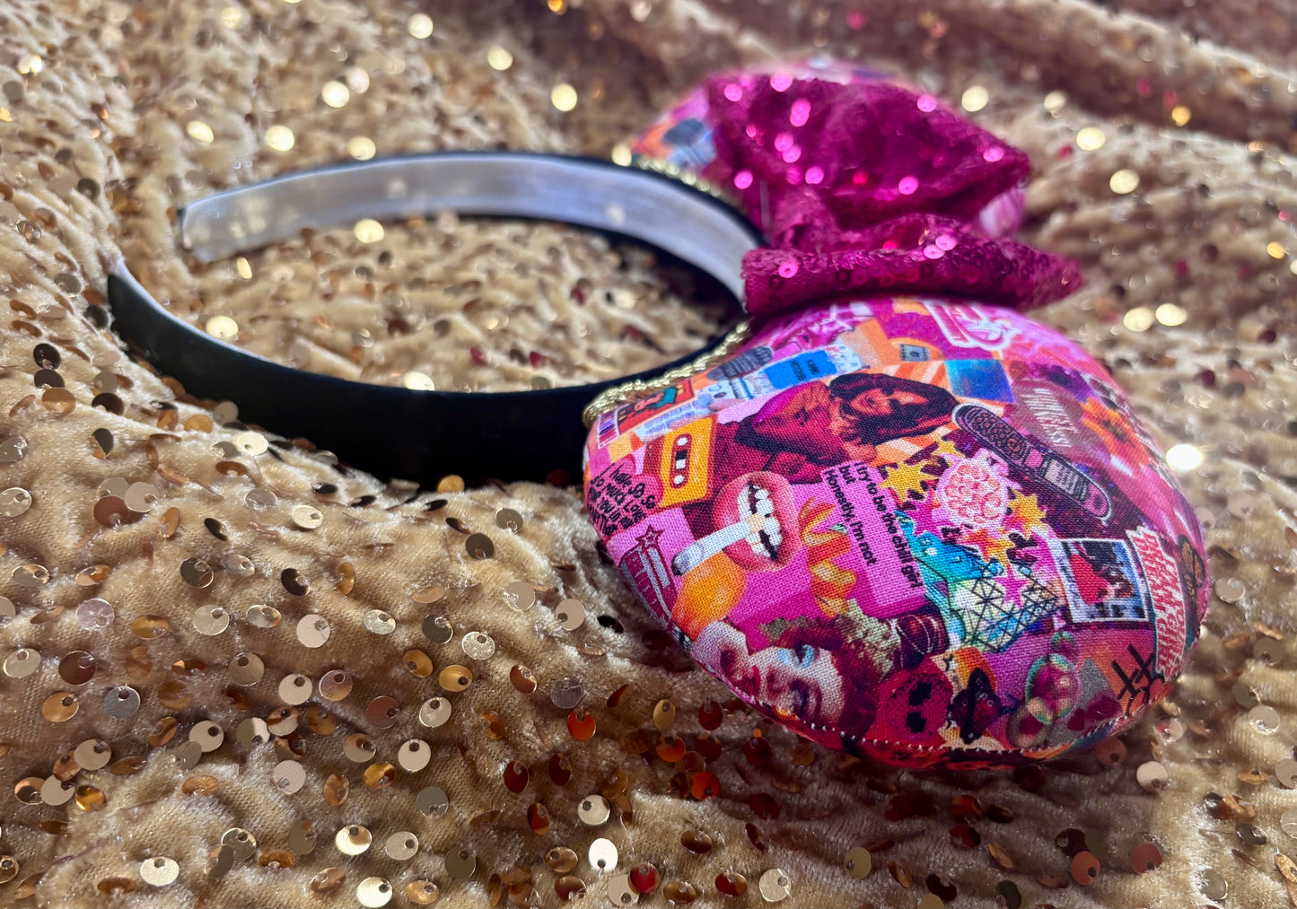 Handmade and ready to ship Colorful Chappell inspired Mouse ears with a hot pink bow on a headband against a gold sequin background.