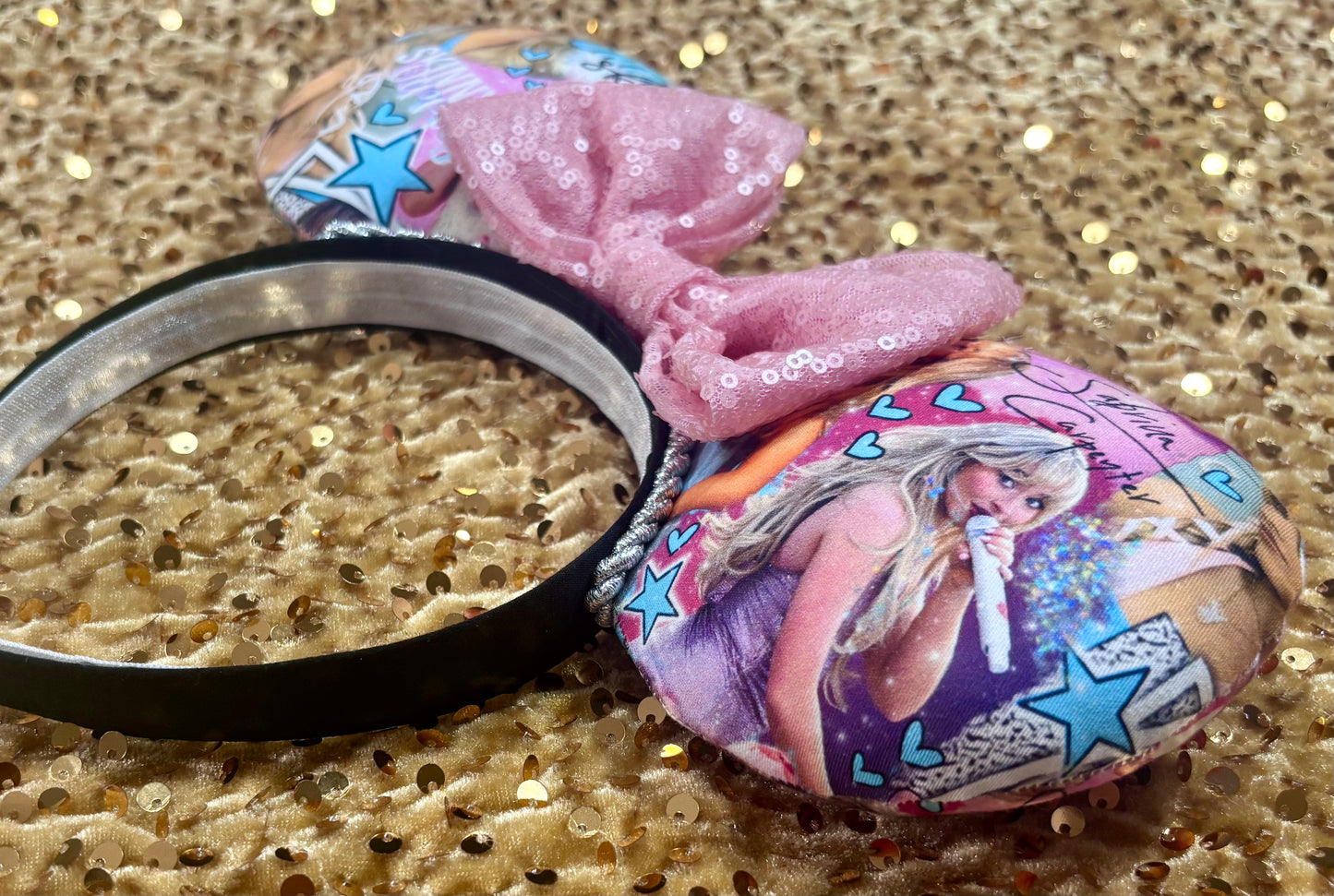 Sabrina Carpenter Short n Sweet Inspired handmade and ready to ship mouse ear headband with a pink sequin bow and silver twisted trim on a black poly cotton universal sized headband. Side view of item.