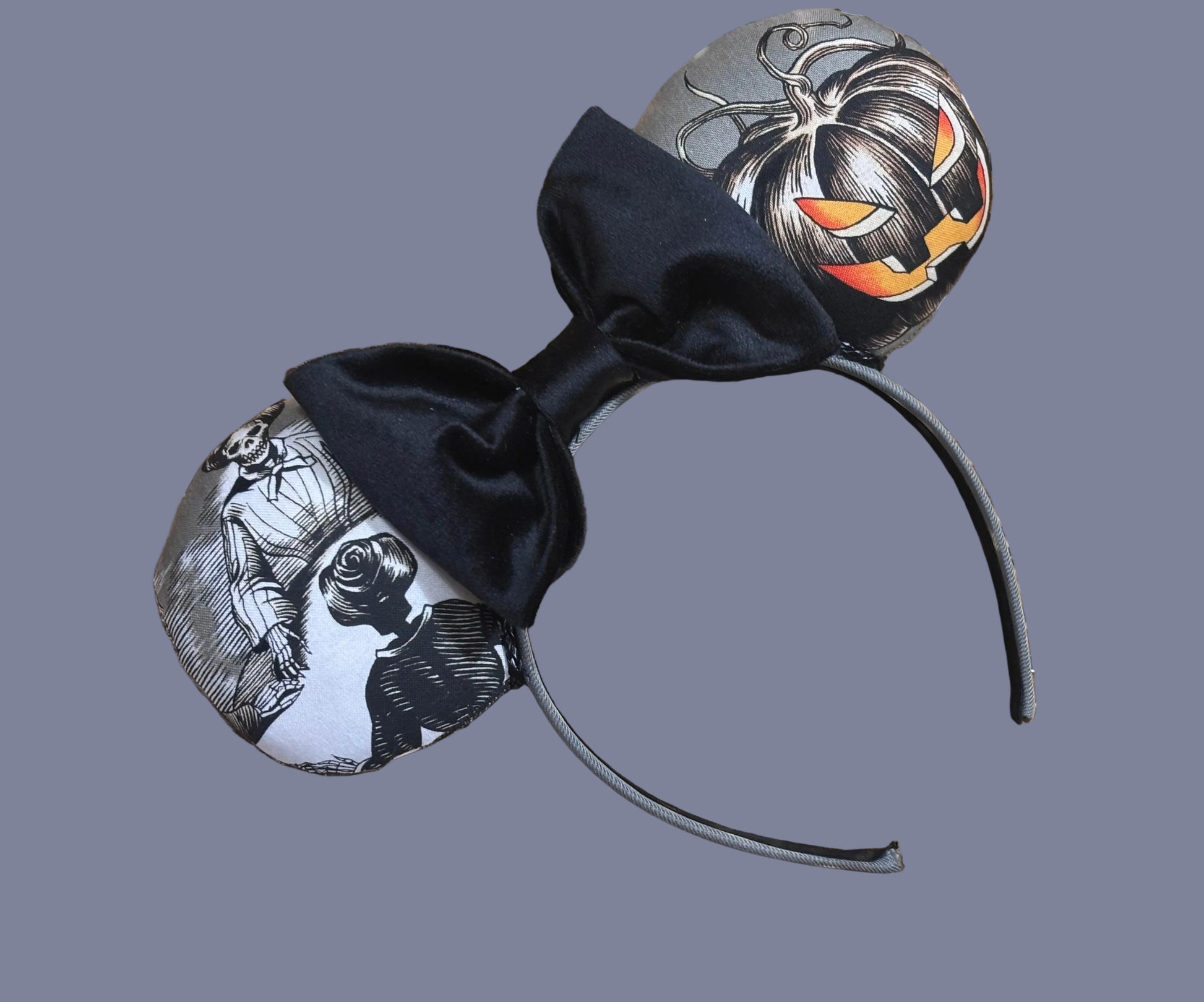 Handmade and one of a kind Halloween mouse ears with the fabric on both the front and back. Skeleton ghost having a seance on one side and an evil pumpkin on the other ear. The headband is grey and universal sized and fits most. The set has a black velvet bow. 
