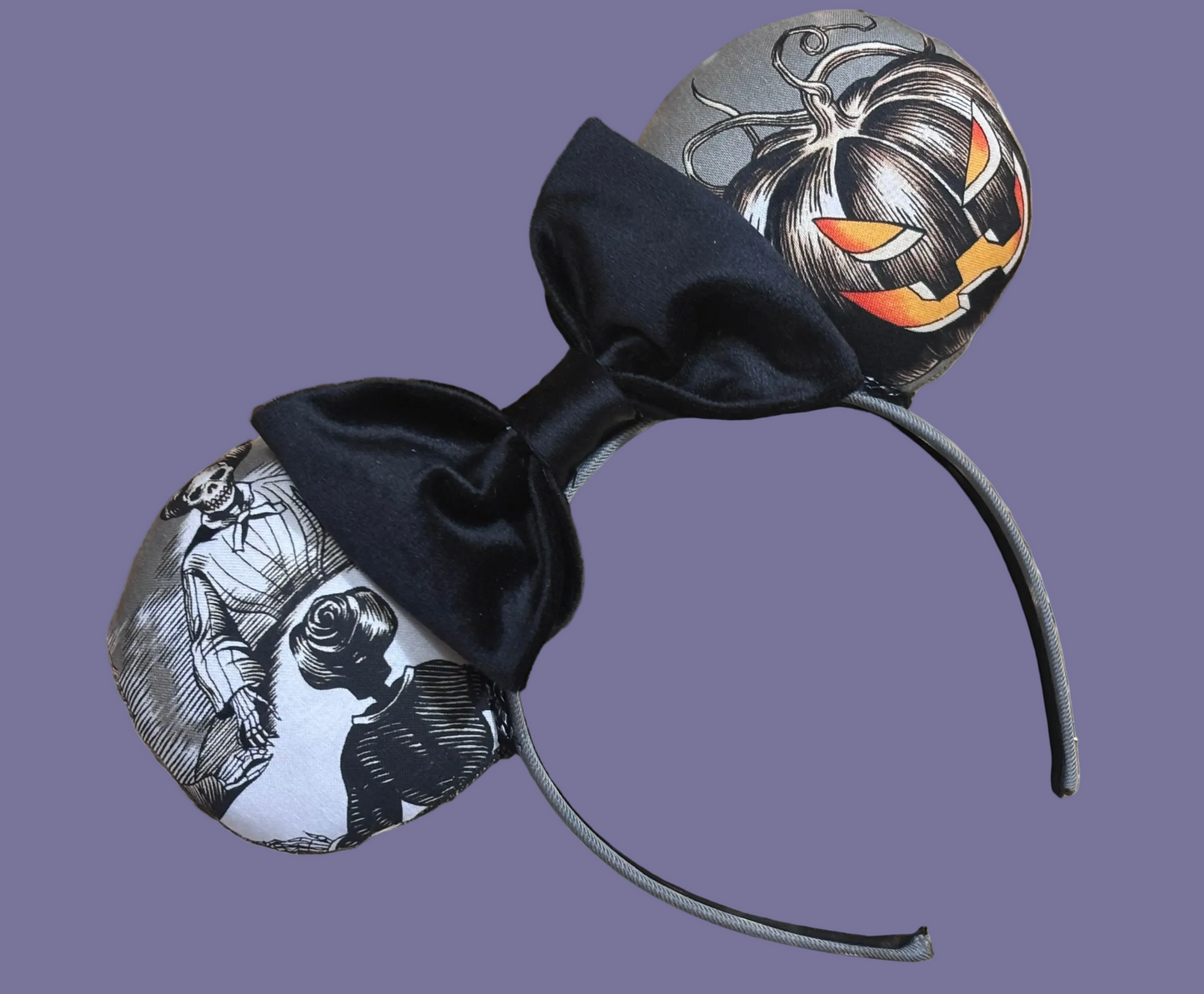 Handmade and one of a kind Halloween mouse ears with the fabric on both the front and back. Skeleton ghost having a seance on one side and an evil pumpkin on the other ear. The headband is grey and universal sized and fits most. The set has a black velvet bow. 