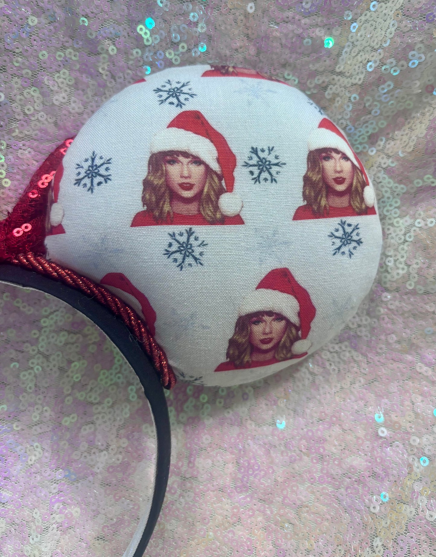 Round fabric item with printed design of a person wearing a Santa hat on a glittery background