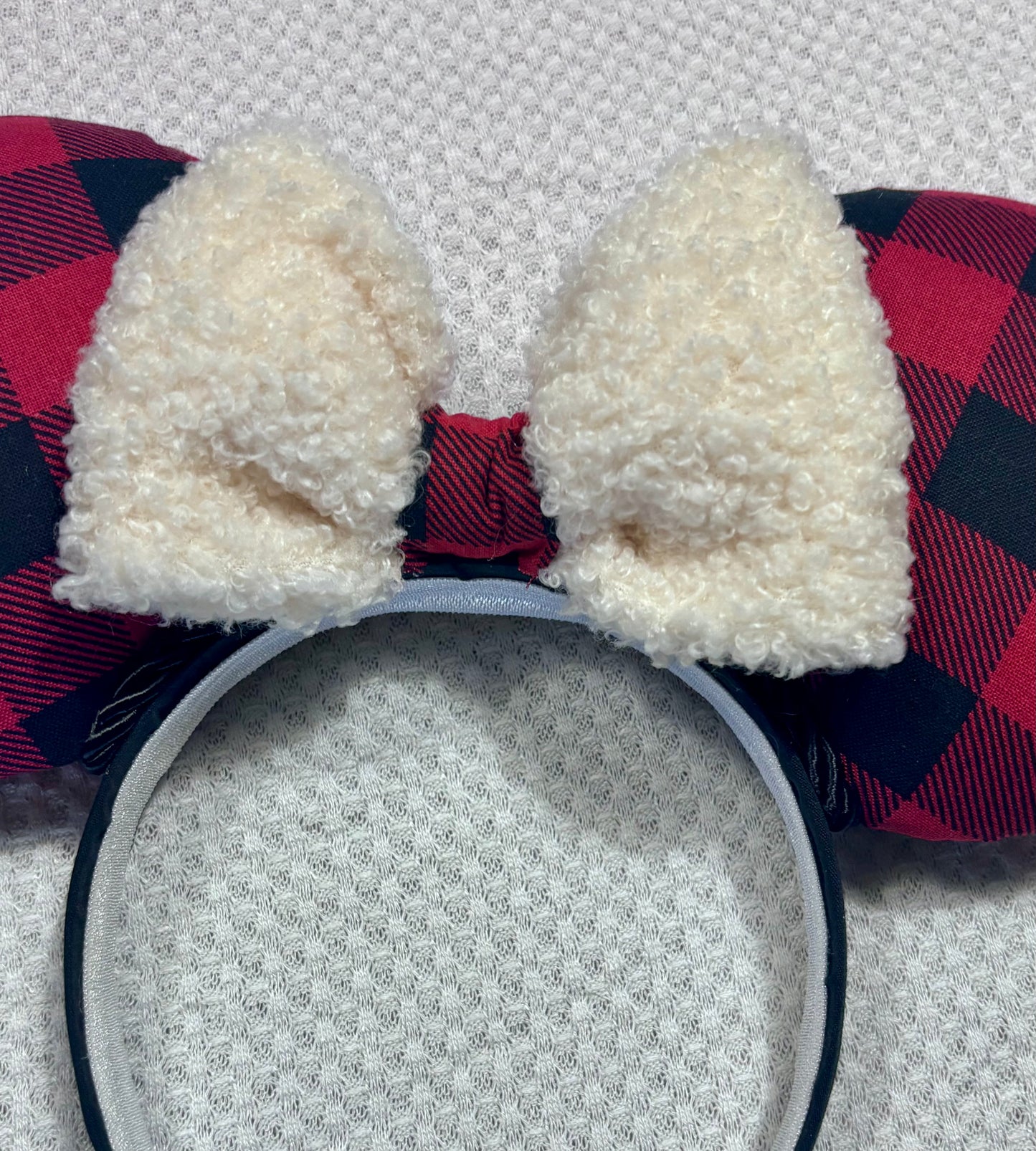Handmade and ready to ship Buffalo Plaid mouse ears on both the front and back. On a black headband that is universal sized. The set has an off-white soft bow with buffalo plaid middle. Item is shown on a white background.