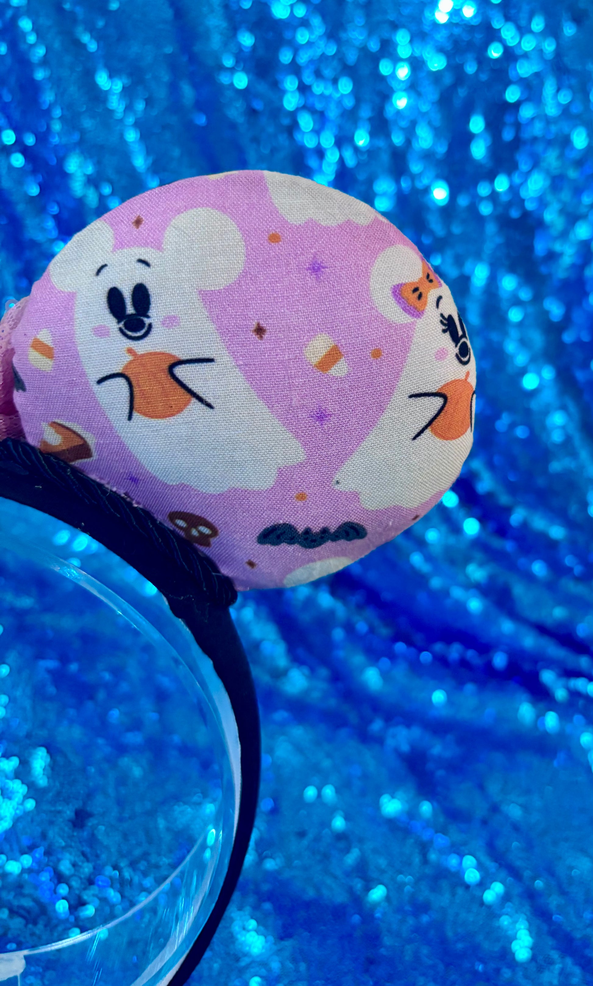 The other back mouse ear on the right side showing the pink fabric with mouse shaped ghosts on it. 