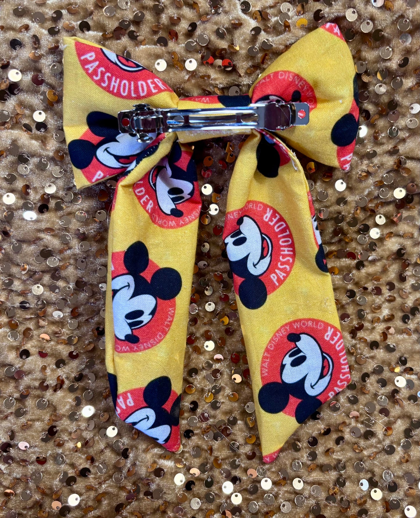 Yellow bow with cartoon character design on a glittery background