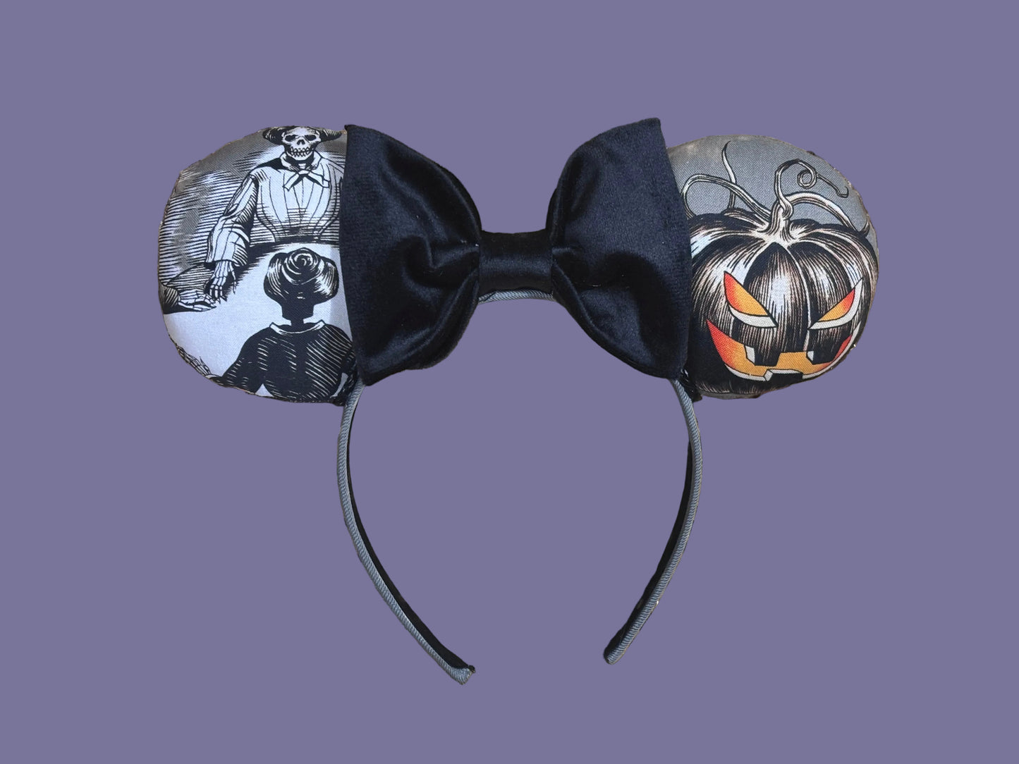 Handmade and one of a kind Halloween mouse ears with the fabric on both the front and back. Skeleton ghost having a seance on one side and an evil pumpkin on the other ear. The headband is grey and universal sized and fits most. The set has a black velvet bow. 