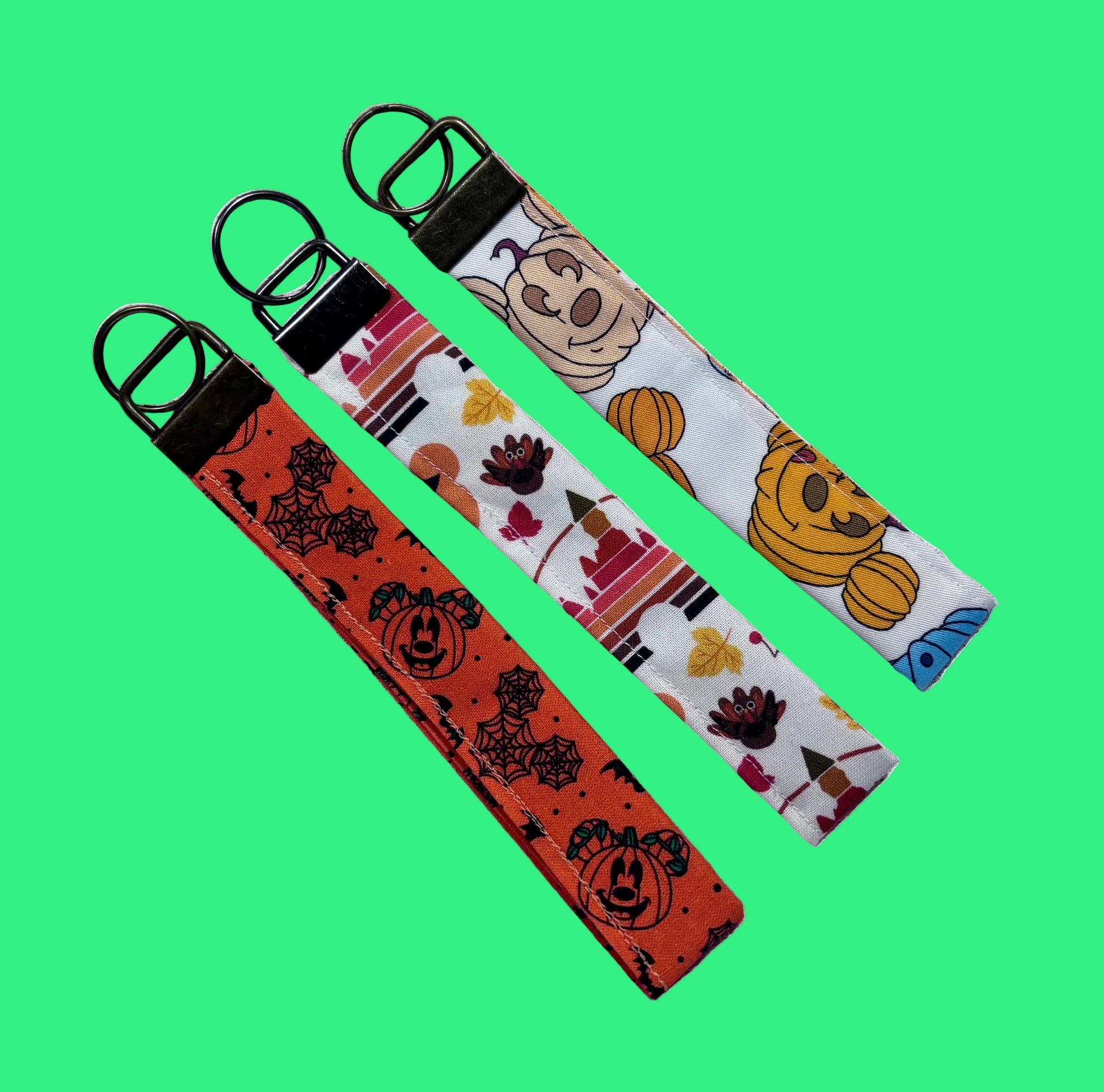 Handmade and ready to ship. Three keychain wristlets with Halloween-themed designs in: Mouse pumpkin, boo to you and thanksgiving fabric designs. 