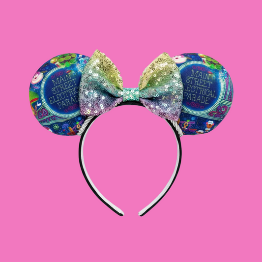 Handmade and ready to ship Main St. Electric Parade Inspired Mouse ears with a rainbow sequin bow with silver twisted trim and on a black universal sized headband.