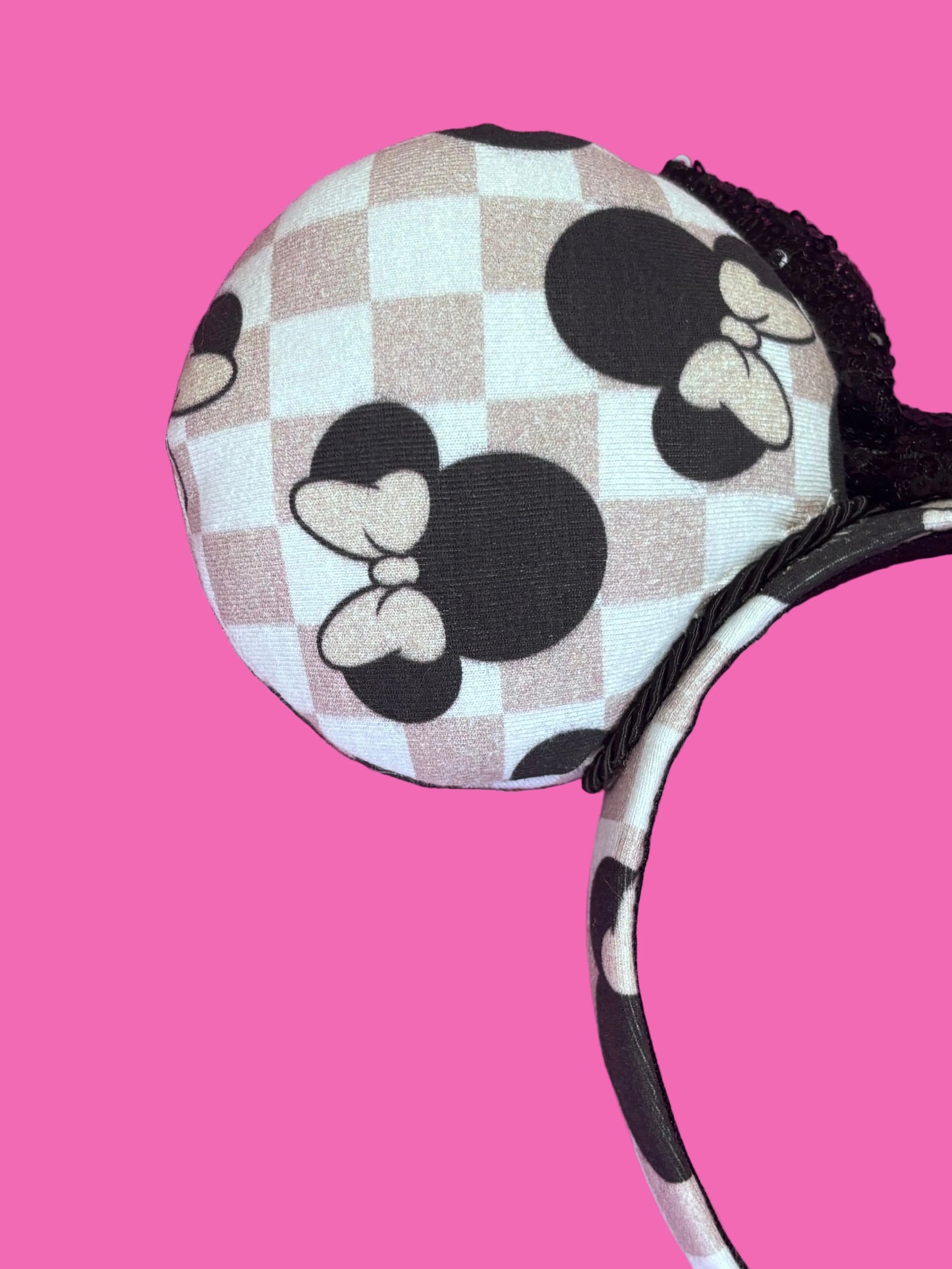 Back left mouse ear view showing the checkered and the mouse ear images. Handmade and ready to ship Checkered Mouse ears with famous Minnie ear bows on the design and a black sequin bow with black twisted trim on a universal sized headband.