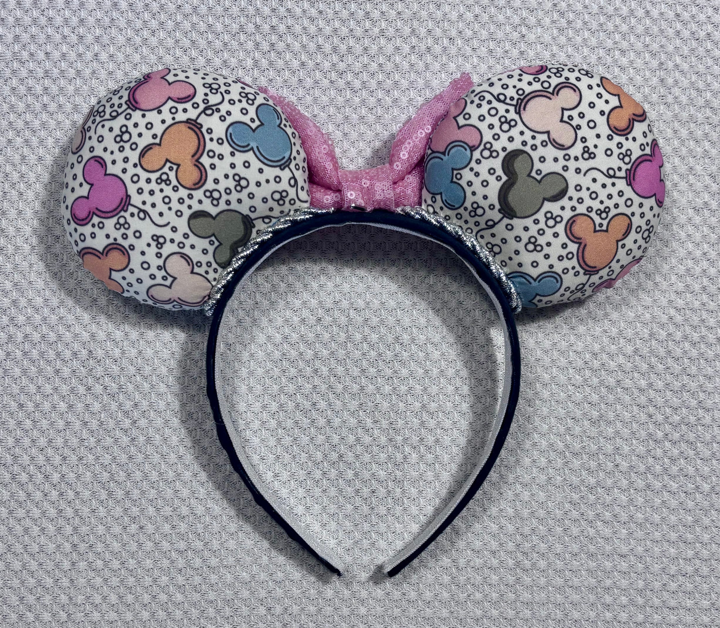 Back view of the mouse ear headband set. Handmade and ready to ship Mouse ears mouse balloons with a light pink sequin bow. Perfect for Main Street. Shown on a white background.