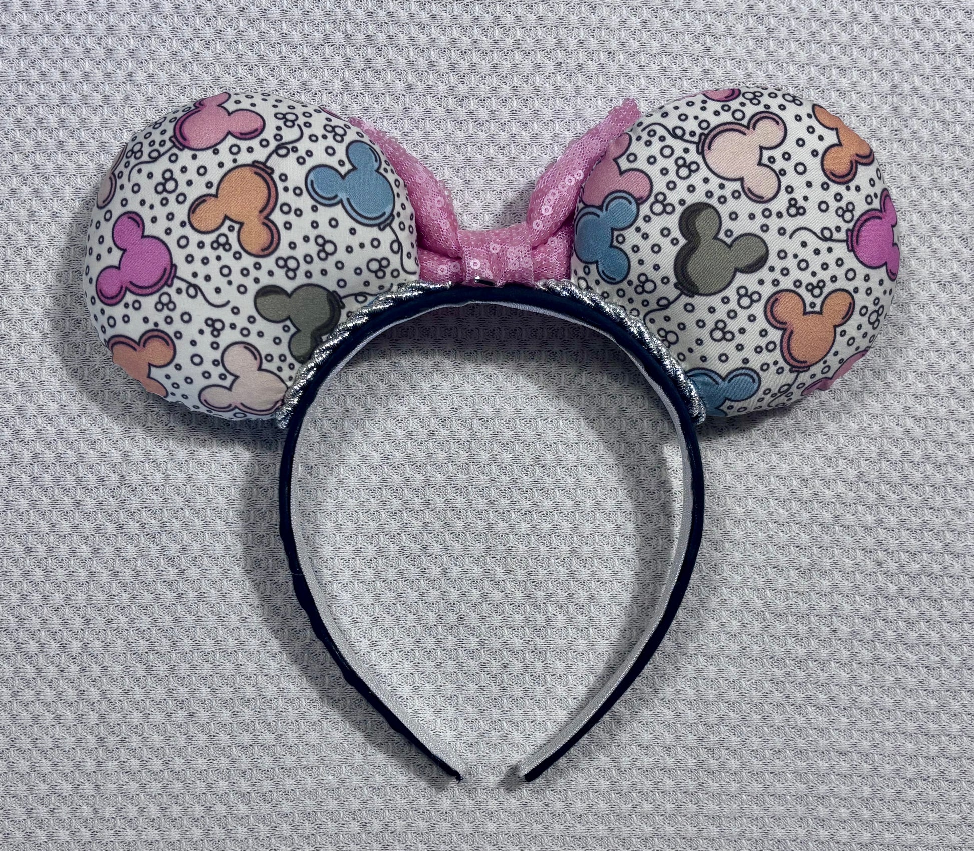 Back view of the mouse ear headband set. Handmade and ready to ship Mouse ears mouse balloons with a light pink sequin bow. Perfect for Main Street. Shown on a white background.