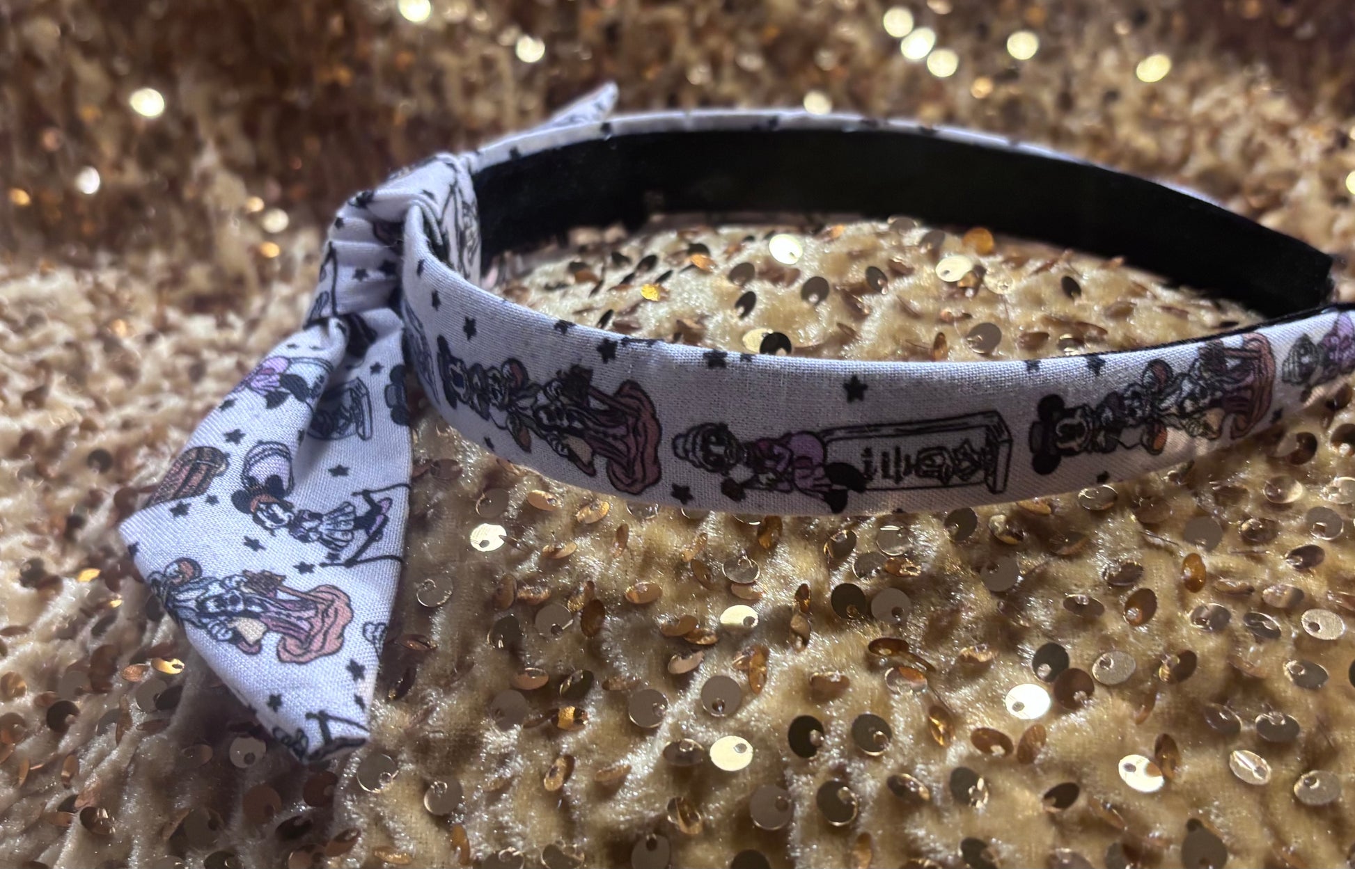 Mickey and friends as the Haunted Mansion stretching room characters on the headband. Other side view.