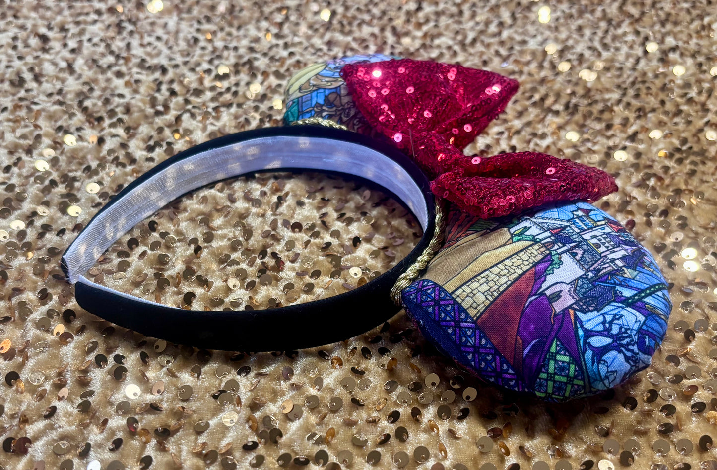 side view of mouse ears and black headband along with the inner headband and elastic lining.