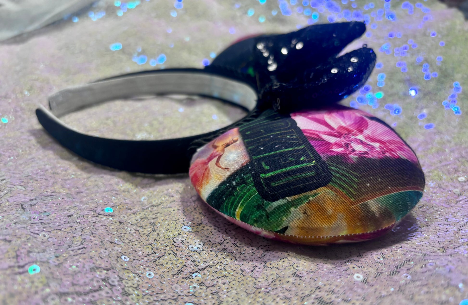 Colorful headband with a bow on a glittery surface