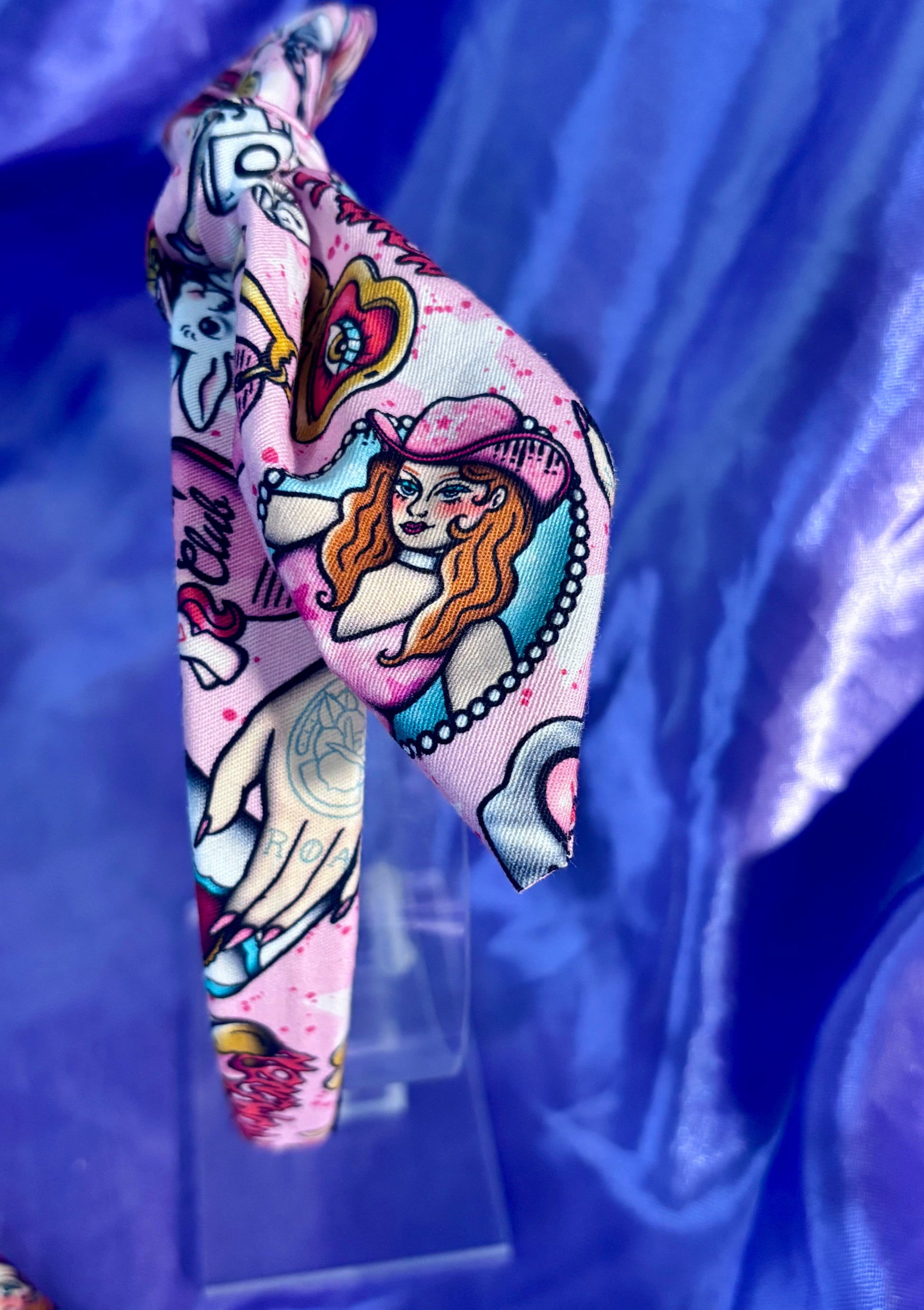 Decorative headband with colorful Chappell inspired designs on a blue background