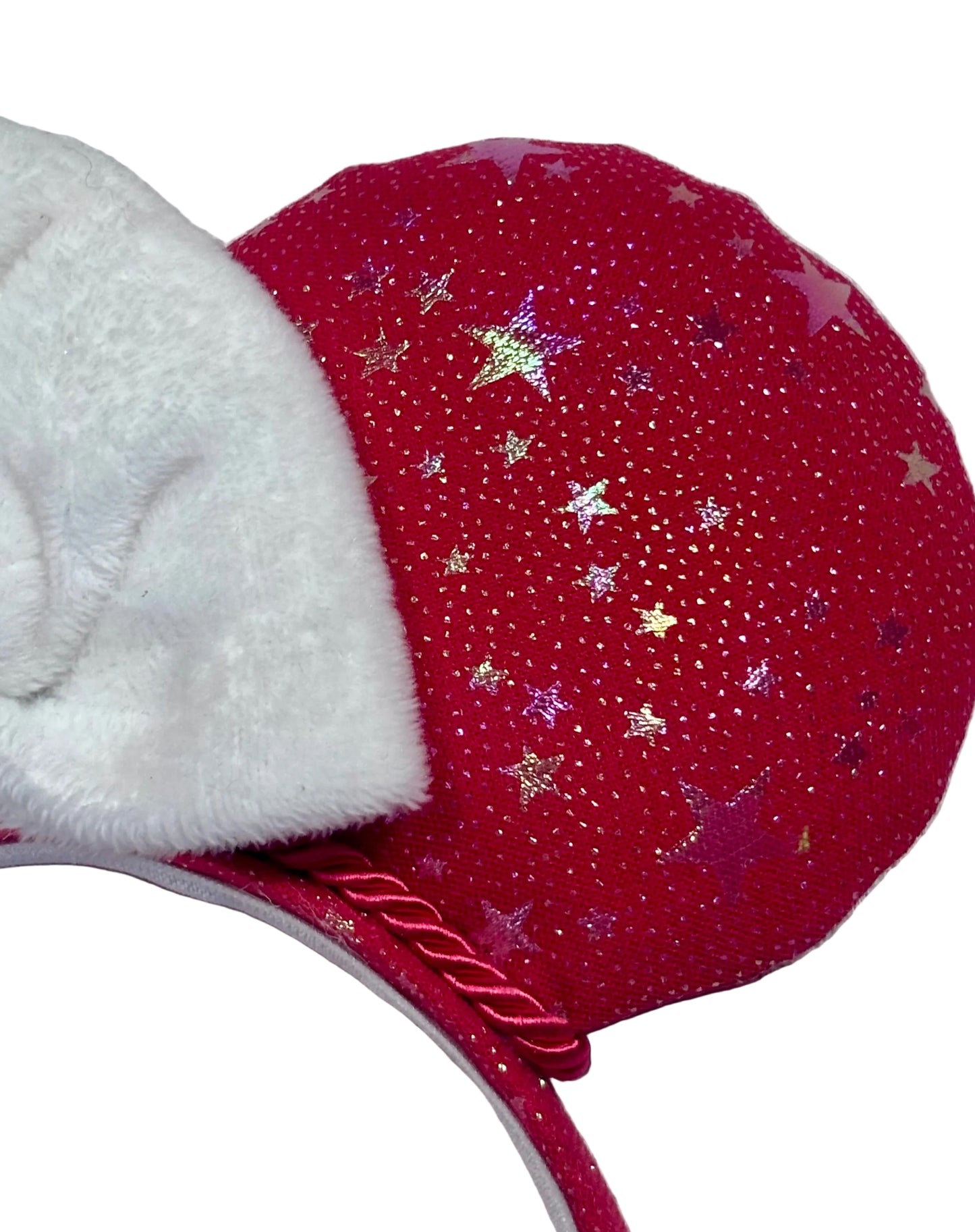 Handmade and ready to ship red mouse ears with iridescent stars on both the front and back along with the headband as well. The set has a white soft bow. Item is shown on a white background.