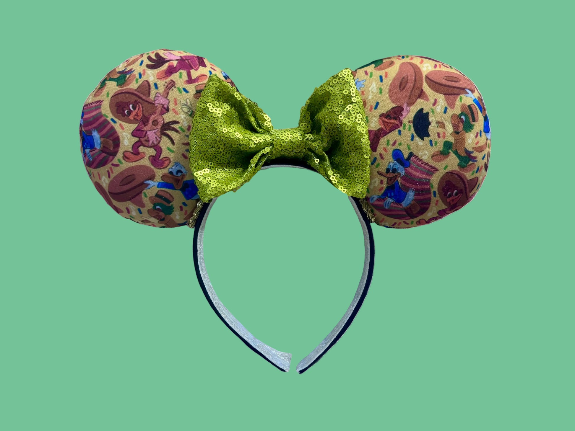 Handmade and ready to ship. These are perfect for Epcot. Three Caballero themed with a lime green sequin bow on a universal sized black poly cotton headband making mouse ears. 