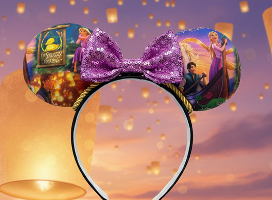  Rapunzel themed minnie ears with a purple sequin bow and gold twisted trim. Shown against a warm, glowing background.