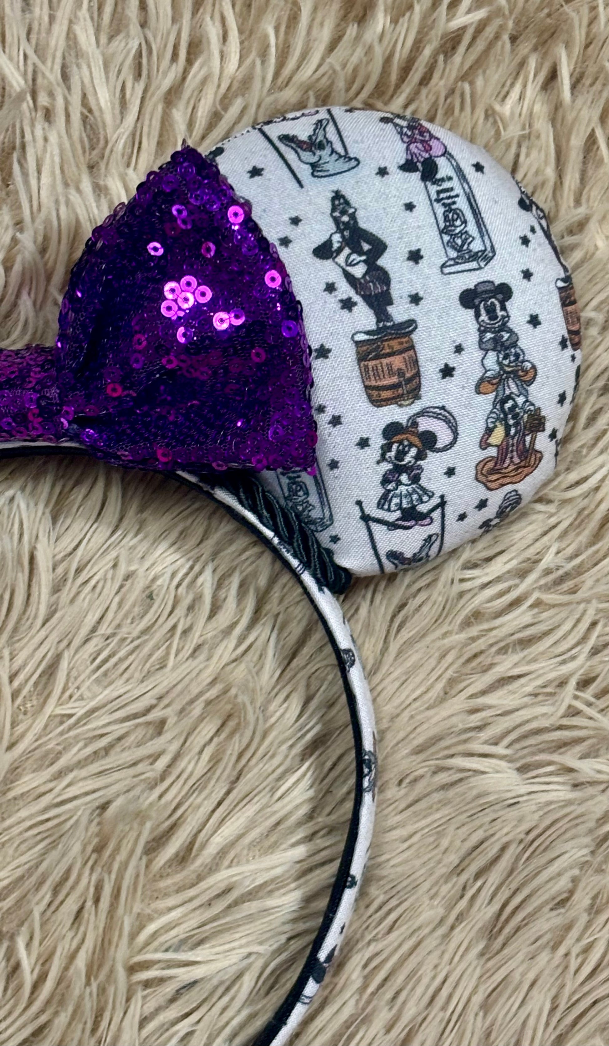 A set of ears with a fab 5 stretching room fabric on the ears front and back along with the headband as well. Black twisted trim along the inner ears with a purple sequin bow. 