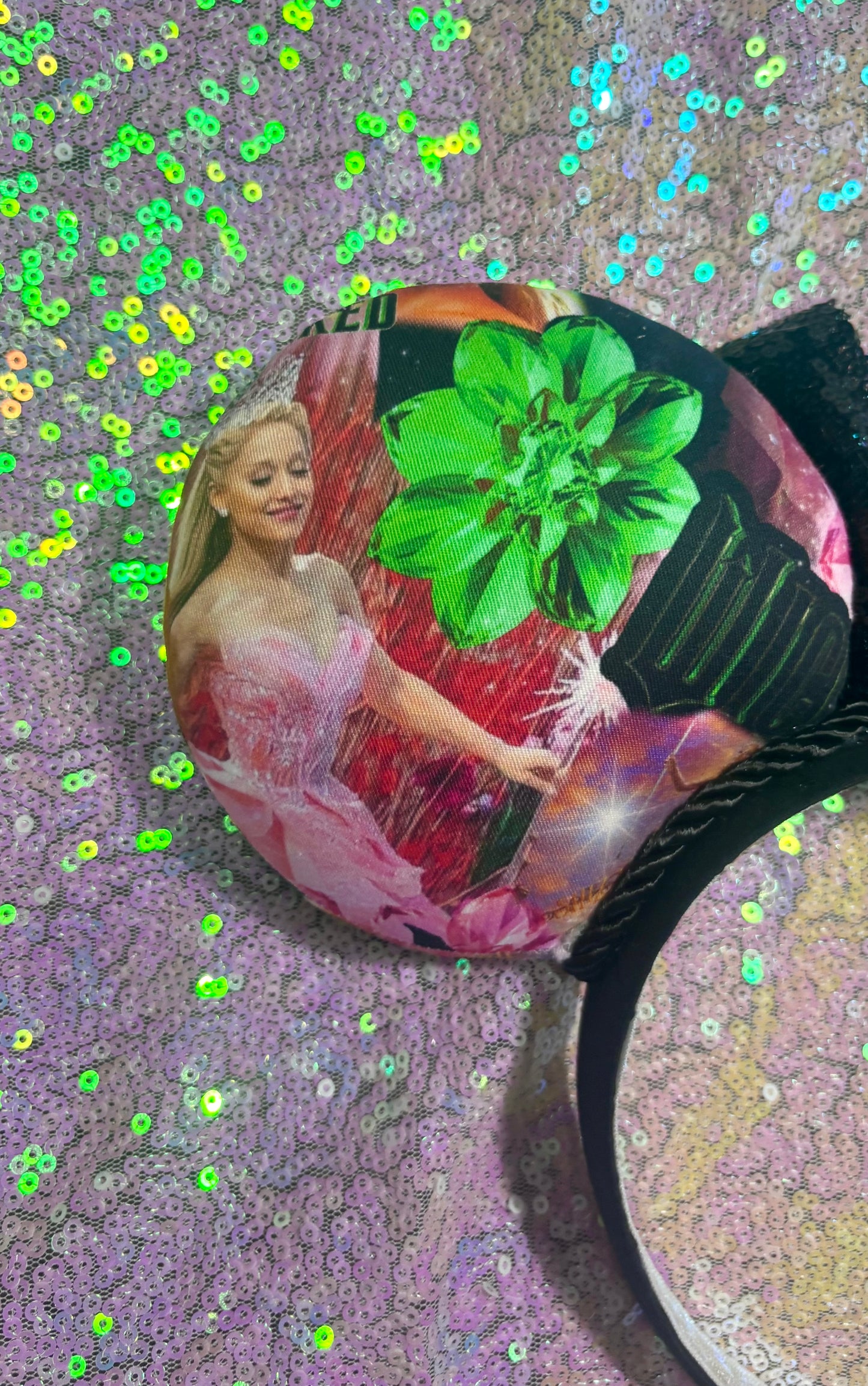 Decorative item with a woman and flower design on a glittery background