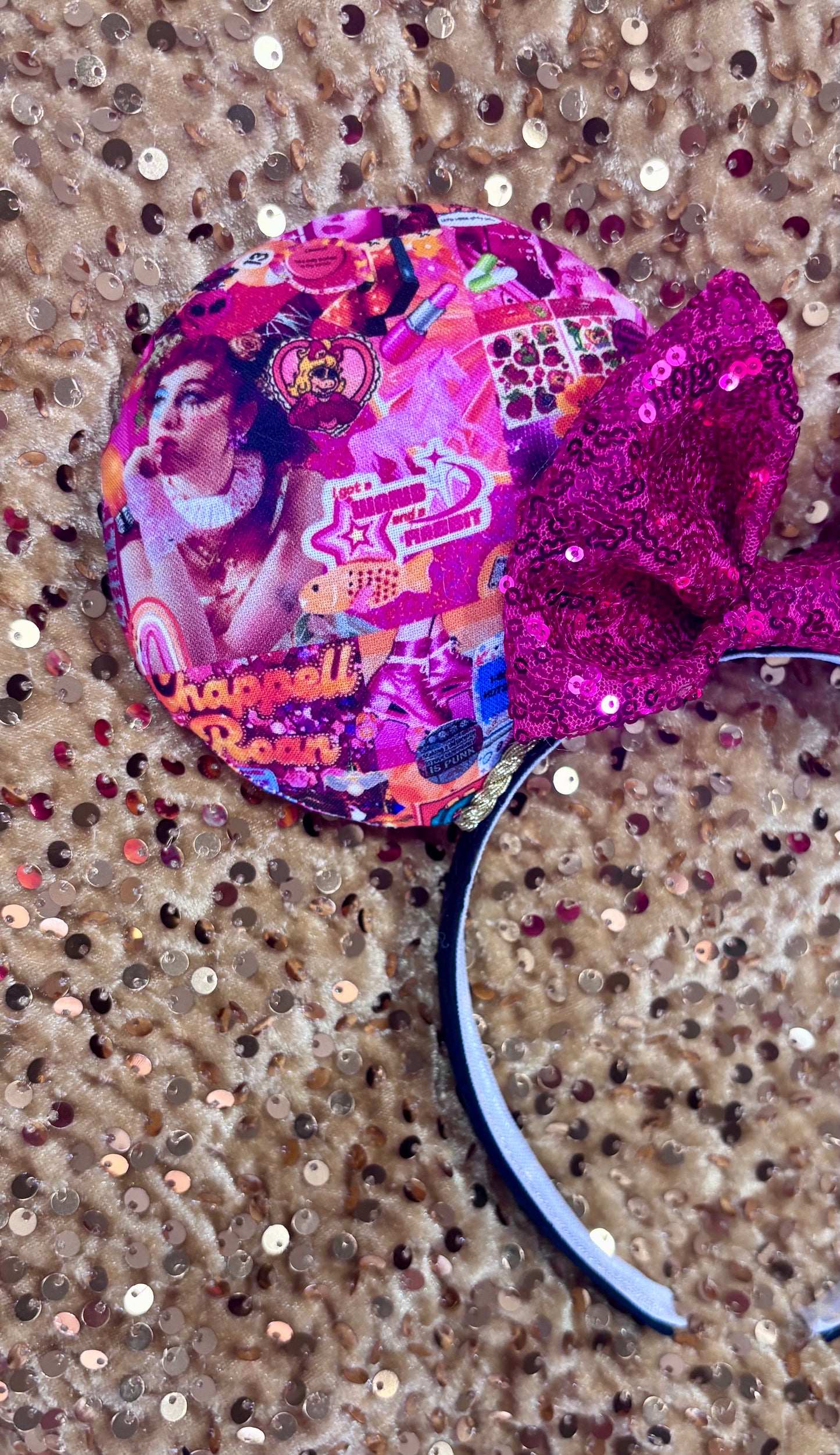 Handmade and ready to ship Colorful Chappell inspired Mouse ears with a hot pink bow on a headband against a gold sequin background.