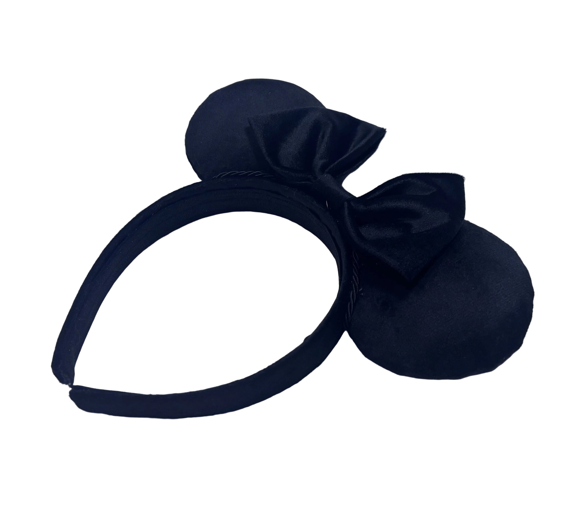 Black Velvet headband with large bow on a textured white background