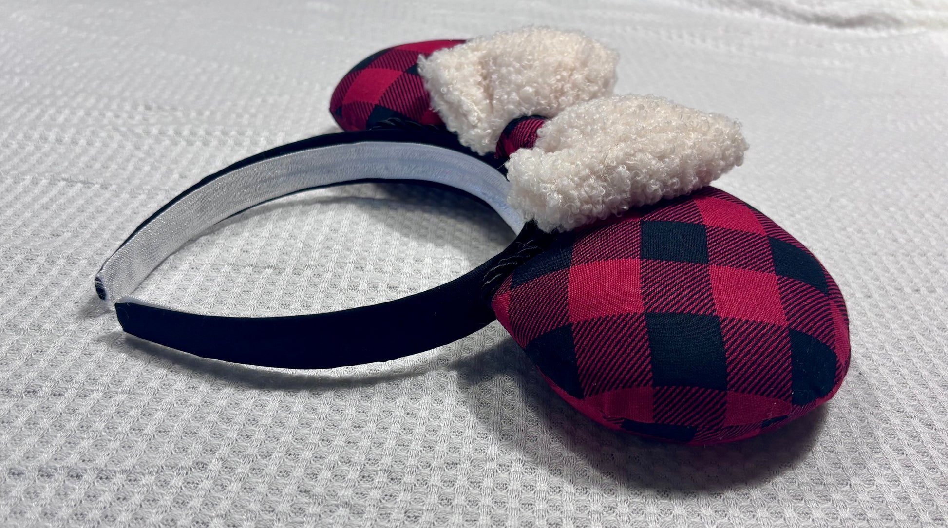 Handmade and ready to ship Buffalo Plaid mouse ears on both the front and back. On a black headband that is universal sized. The set has an off-white soft bow with buffalo plaid middle. Item is shown on a white background.