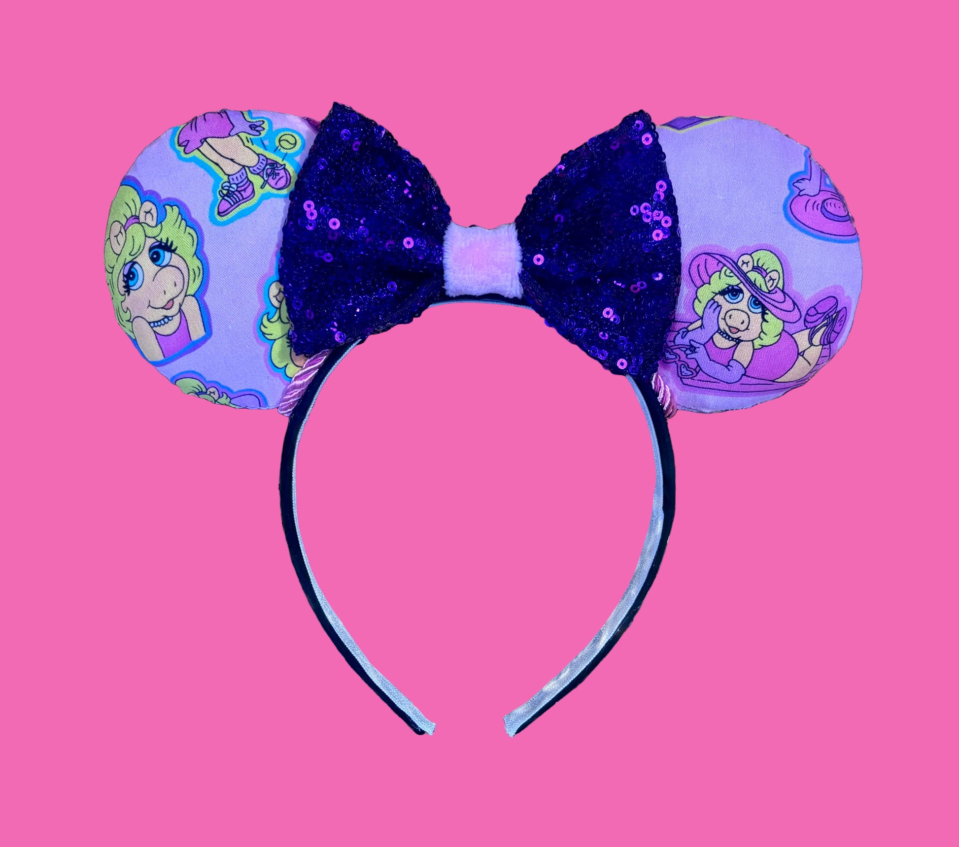 Handmade and ready to ship Piggy mouse ears. Miss Piggy fabric is on the front and the back. On a universal sized black poly fabric headband. With a purple sequin with pink soft middle on the bow. 