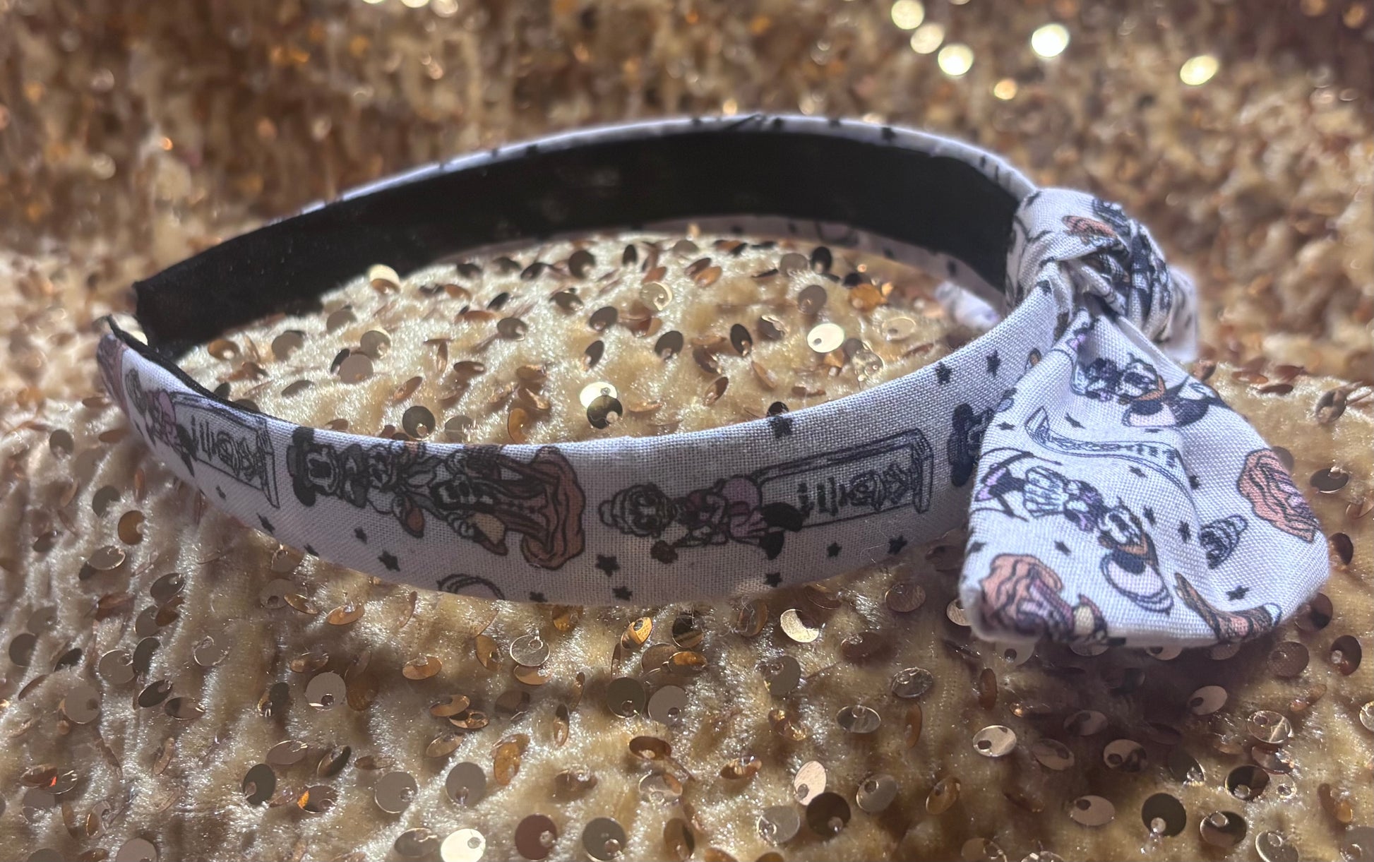 Close up of Mickey and friends as the Haunted Mansion stretching room characters on the headband. Side view.
