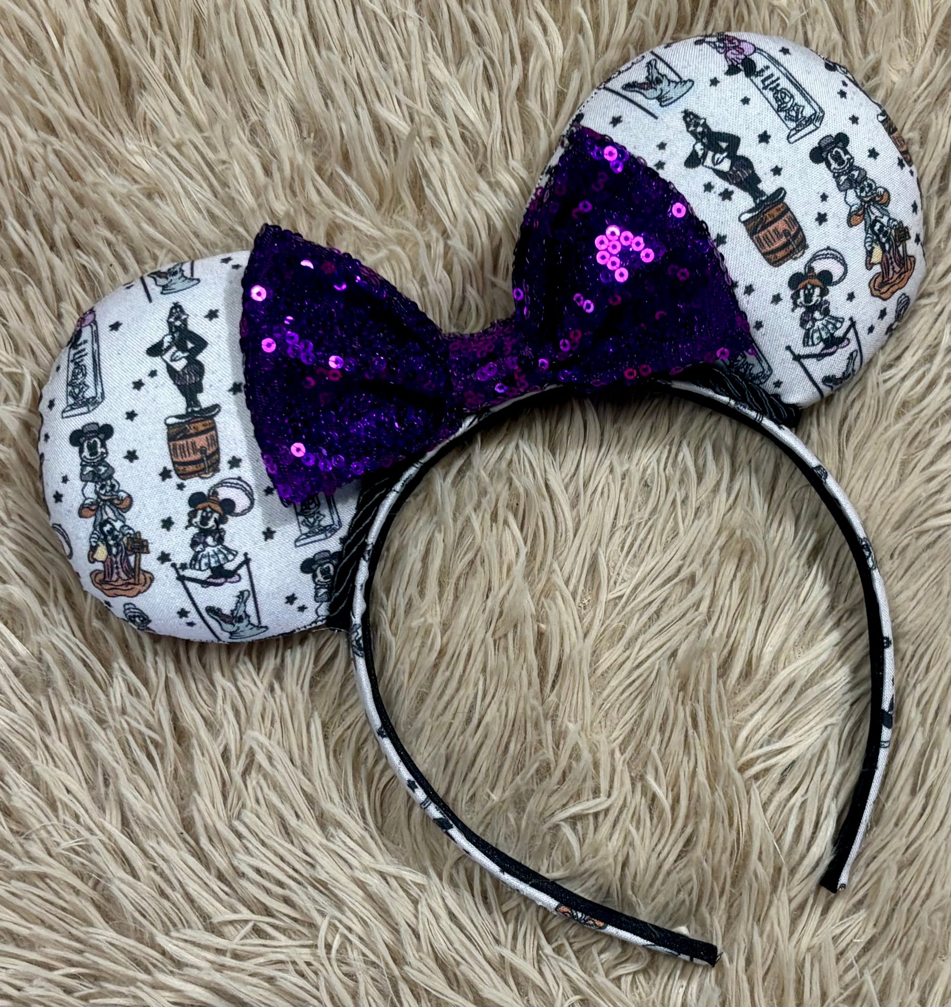 A set of ears with a fab 5 stretching room fabric on the ears front and back along with the headband as well. Black twisted trim along the inner ears with a purple sequin bow. 