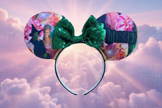 Mouse ears with a green sequin bow. Shown on a cloud background