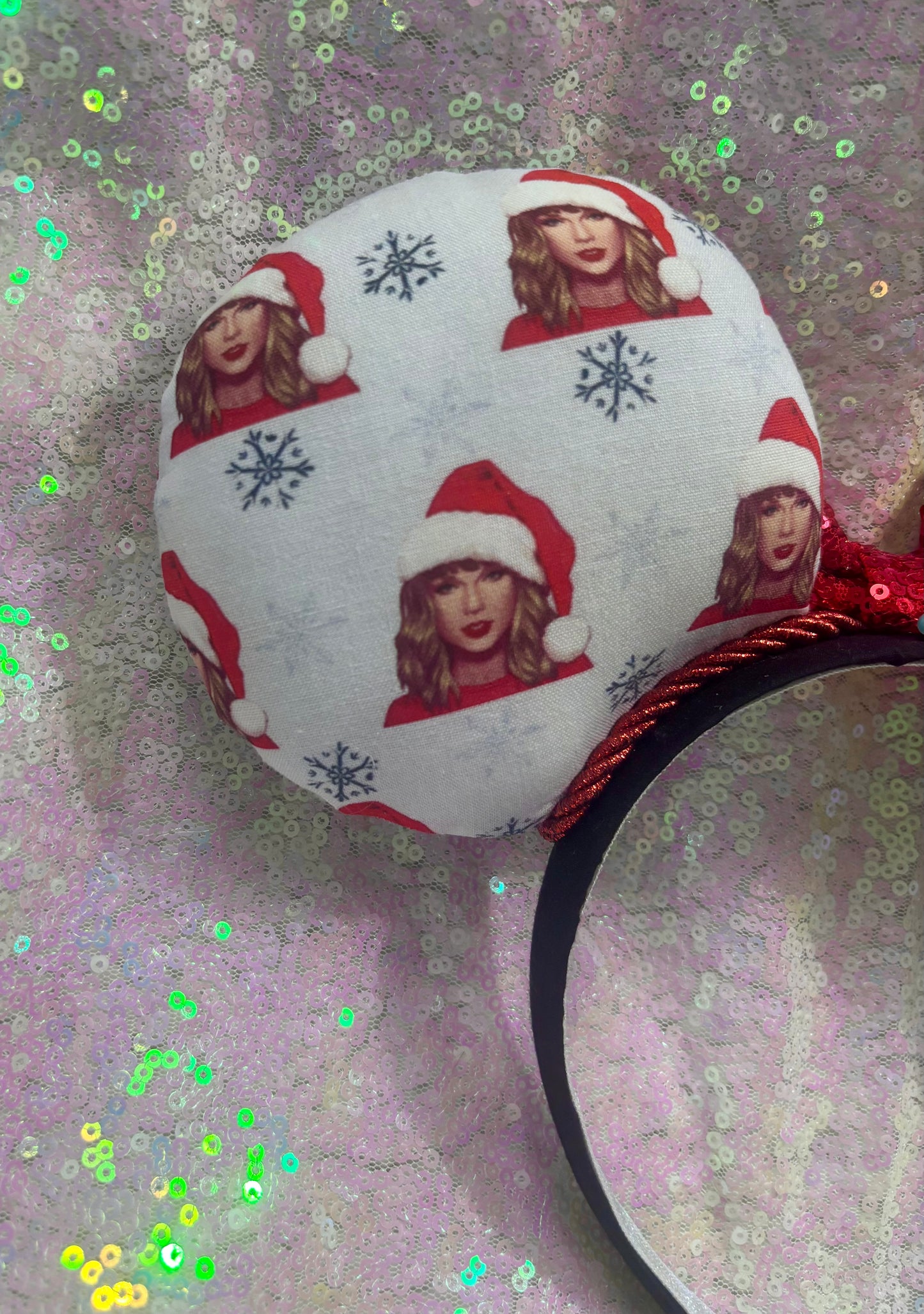 Mouse ear headband with red bow and character print on a glittery background